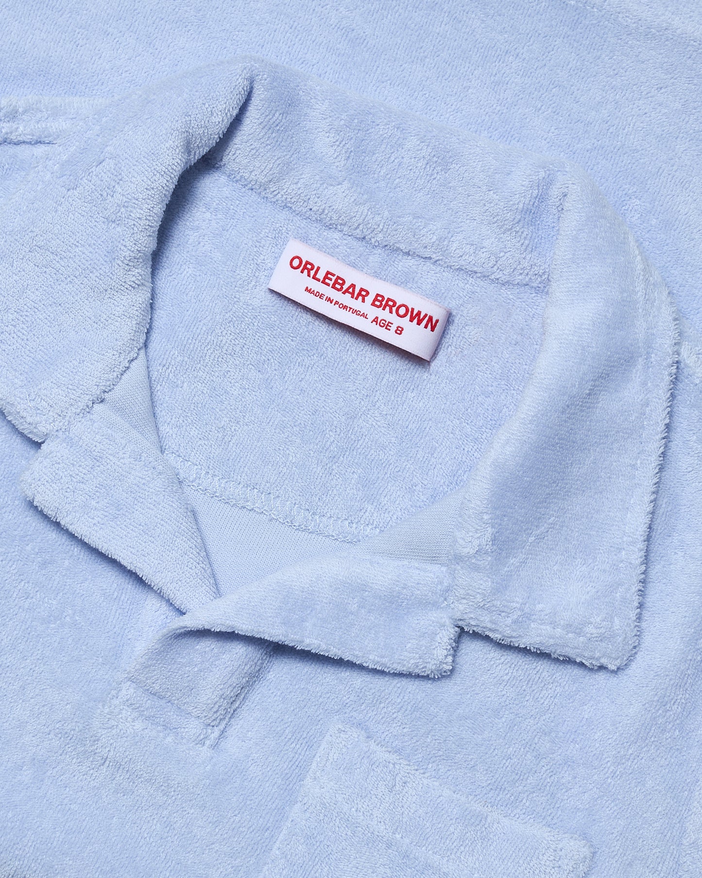 Light blue towel with a visible Orlebar Brown label.