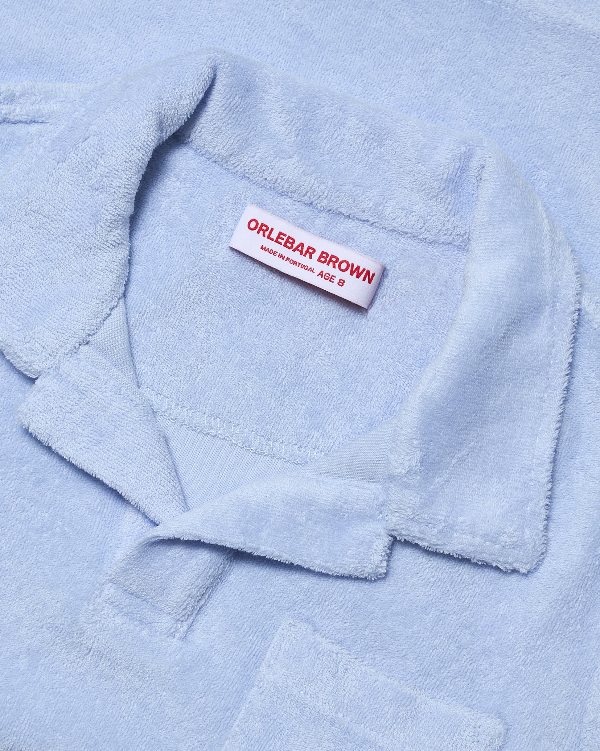 Light blue towel with a visible Orlebar Brown label.