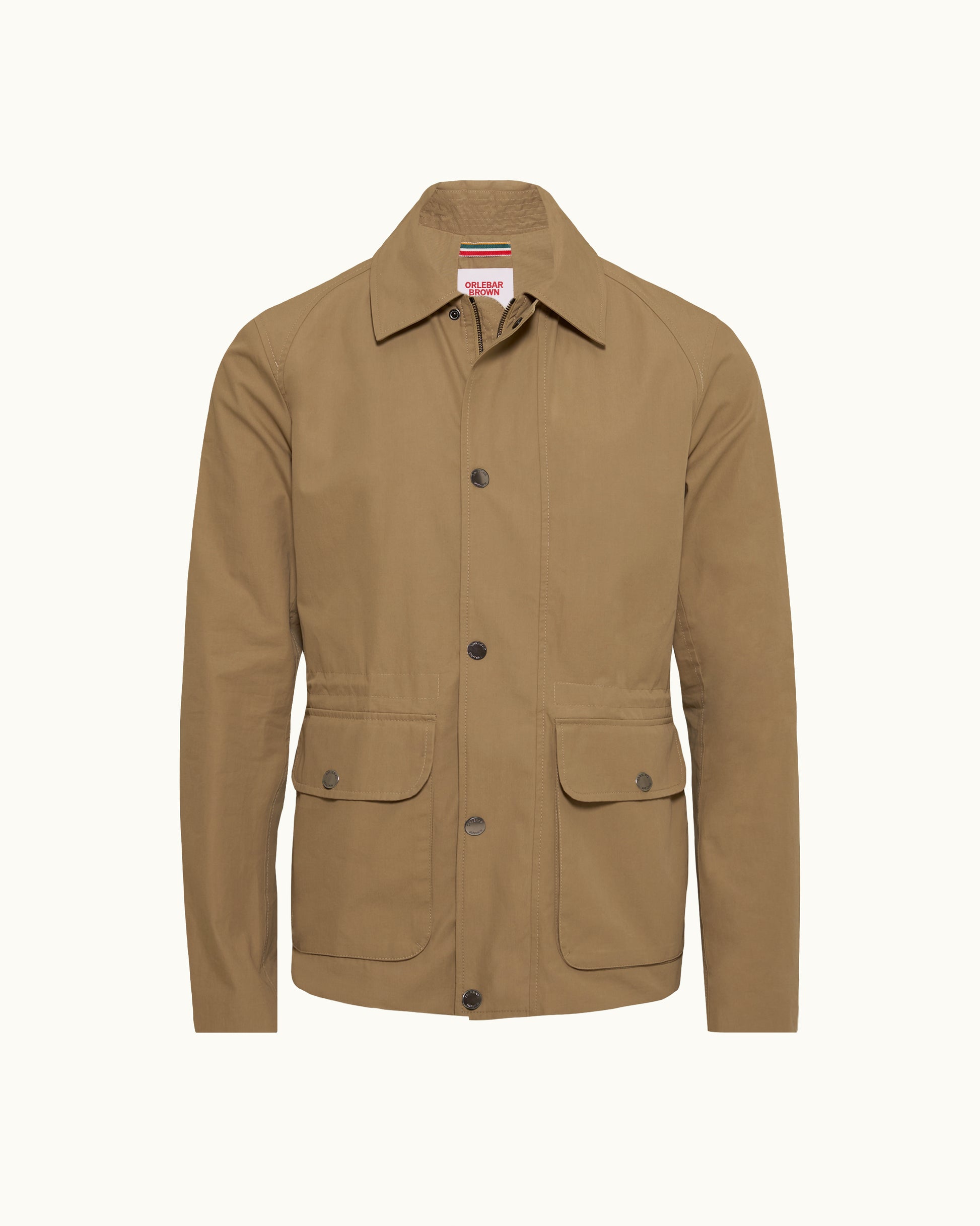 A tan utility jacket with a pointed collar, dark snap buttons, and two front flap pockets, shown on a plain off-white background.