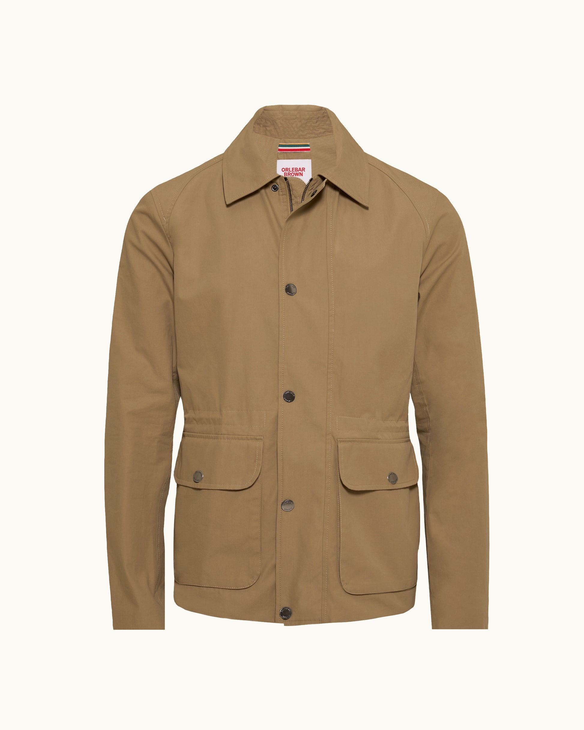 A tan utility jacket with a pointed collar, button front, and two large flap pockets on a light cream background.
