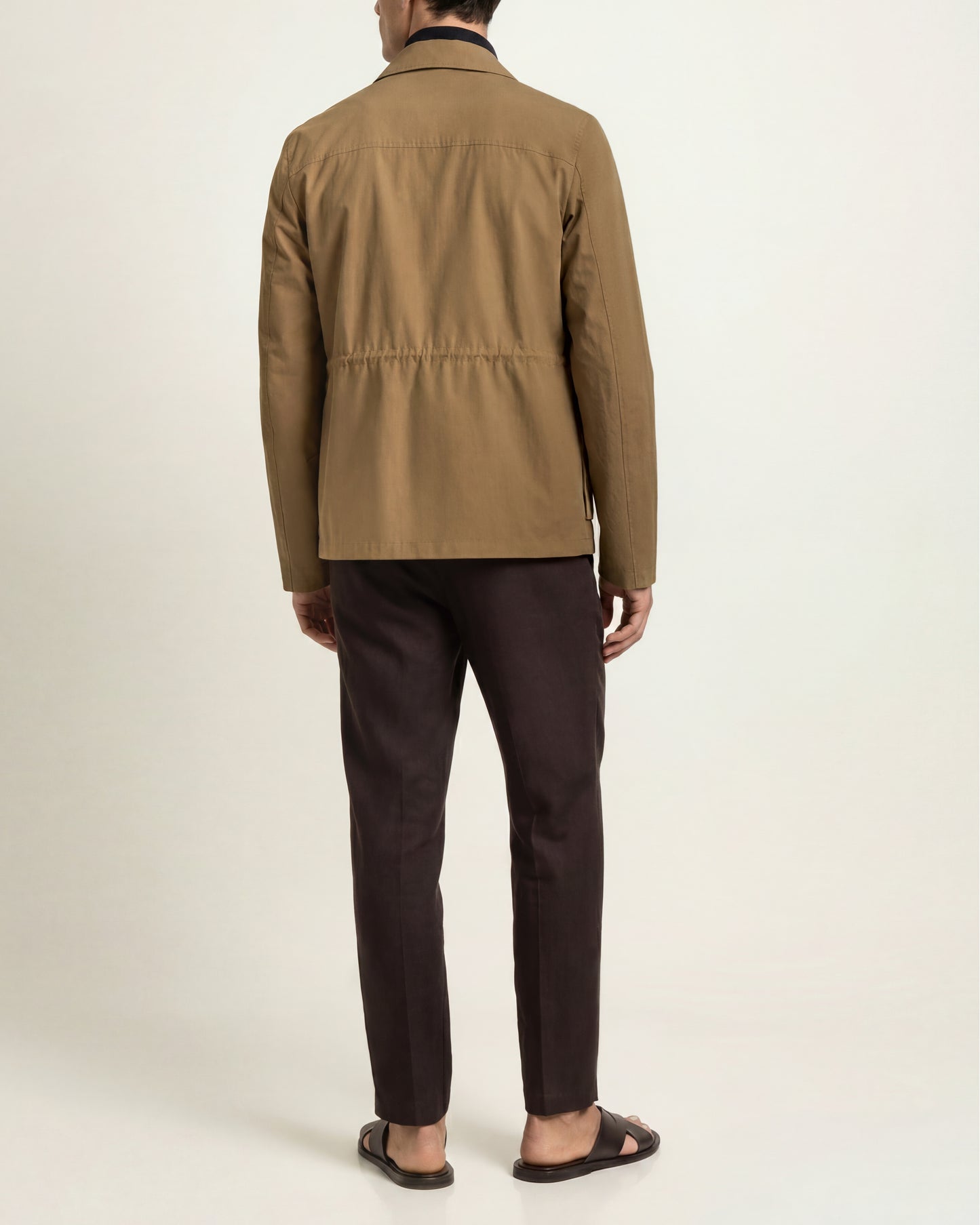 Model image showing back of Utility jacket in Dijon beige 