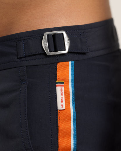 Navy shorts with a colorful belt and brand label.