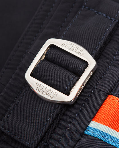 Close-up of a silver buckle and orange and blue stripes.