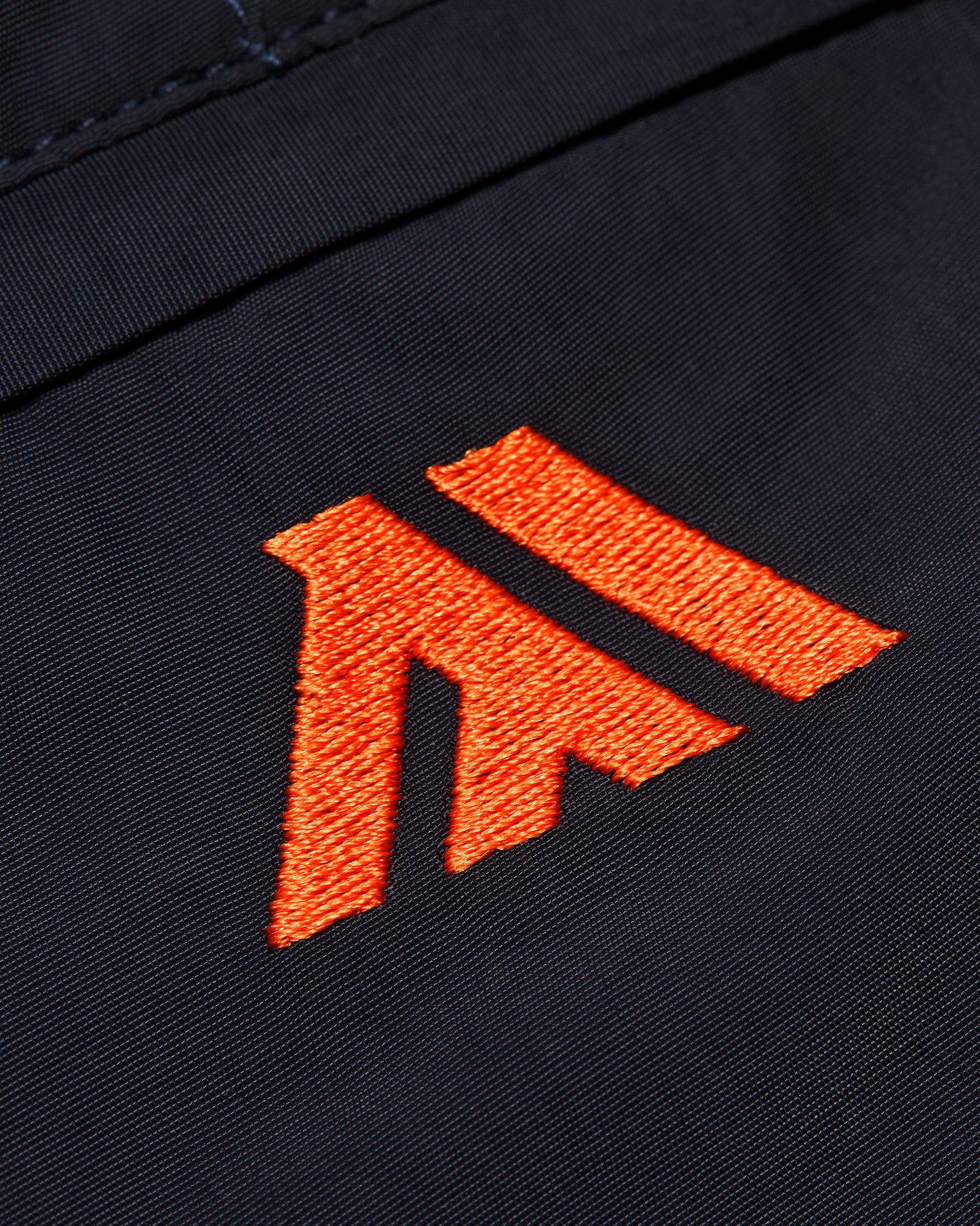 Orange logo on a black background