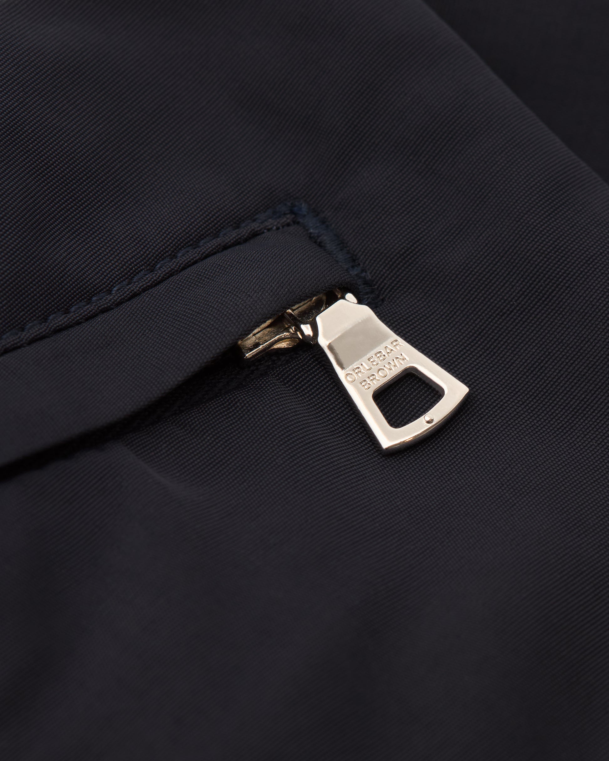 Close-up of a zipper on a dark fabric background