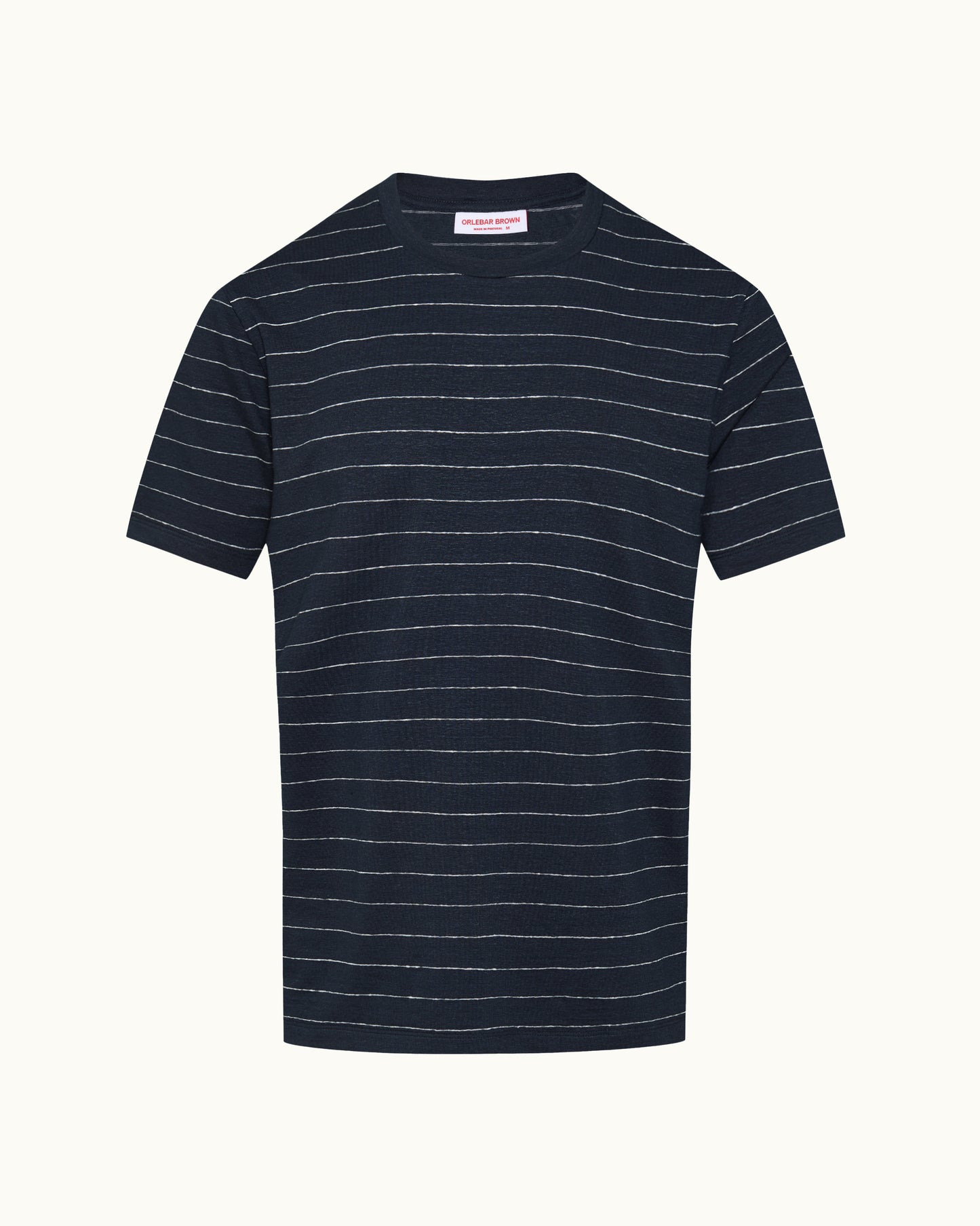 A navy blue short-sleeve crewneck t-shirt with thin white horizontal stripes, displayed flat against a light cream background.