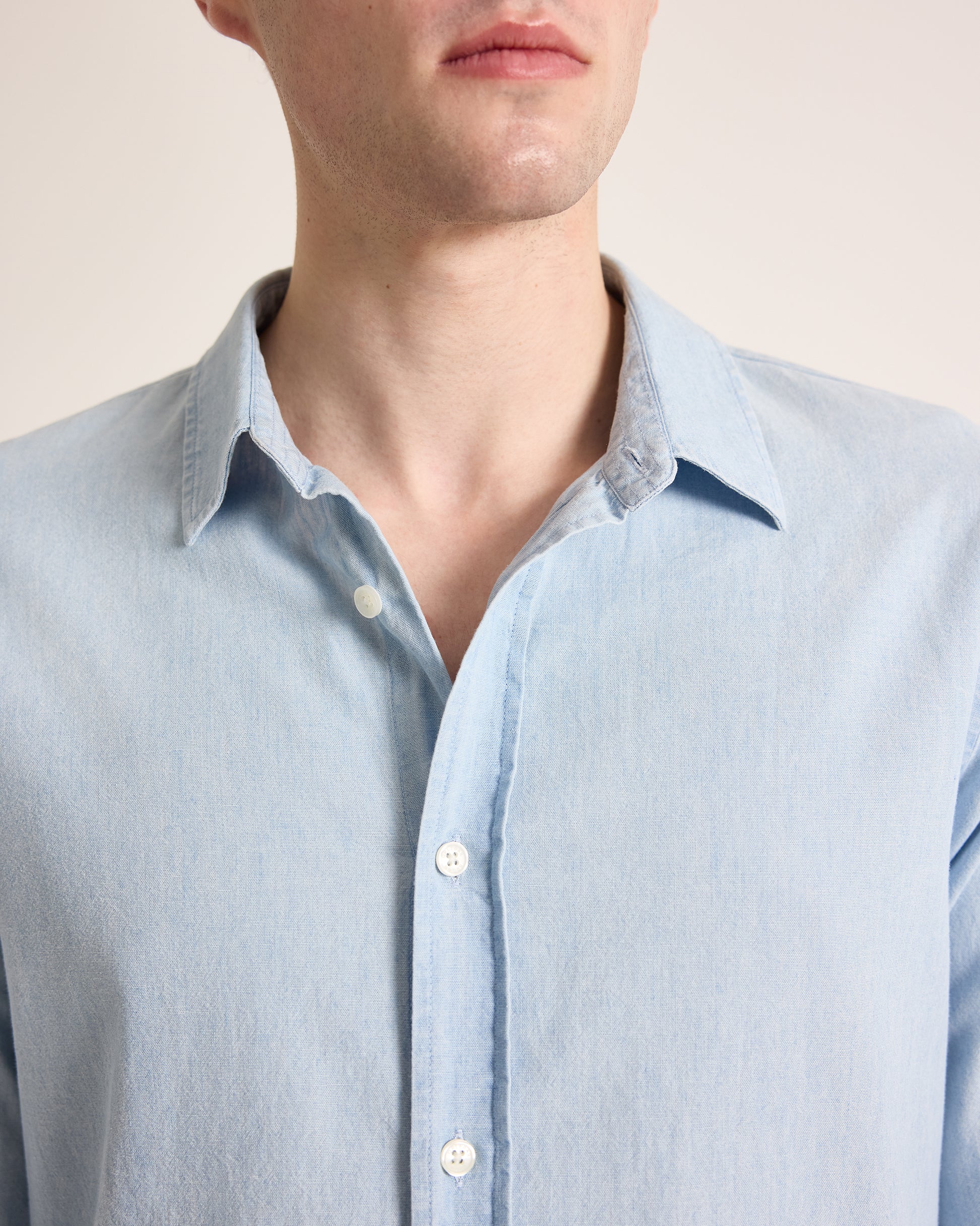 Light blue shirt worn by a person on a plain background