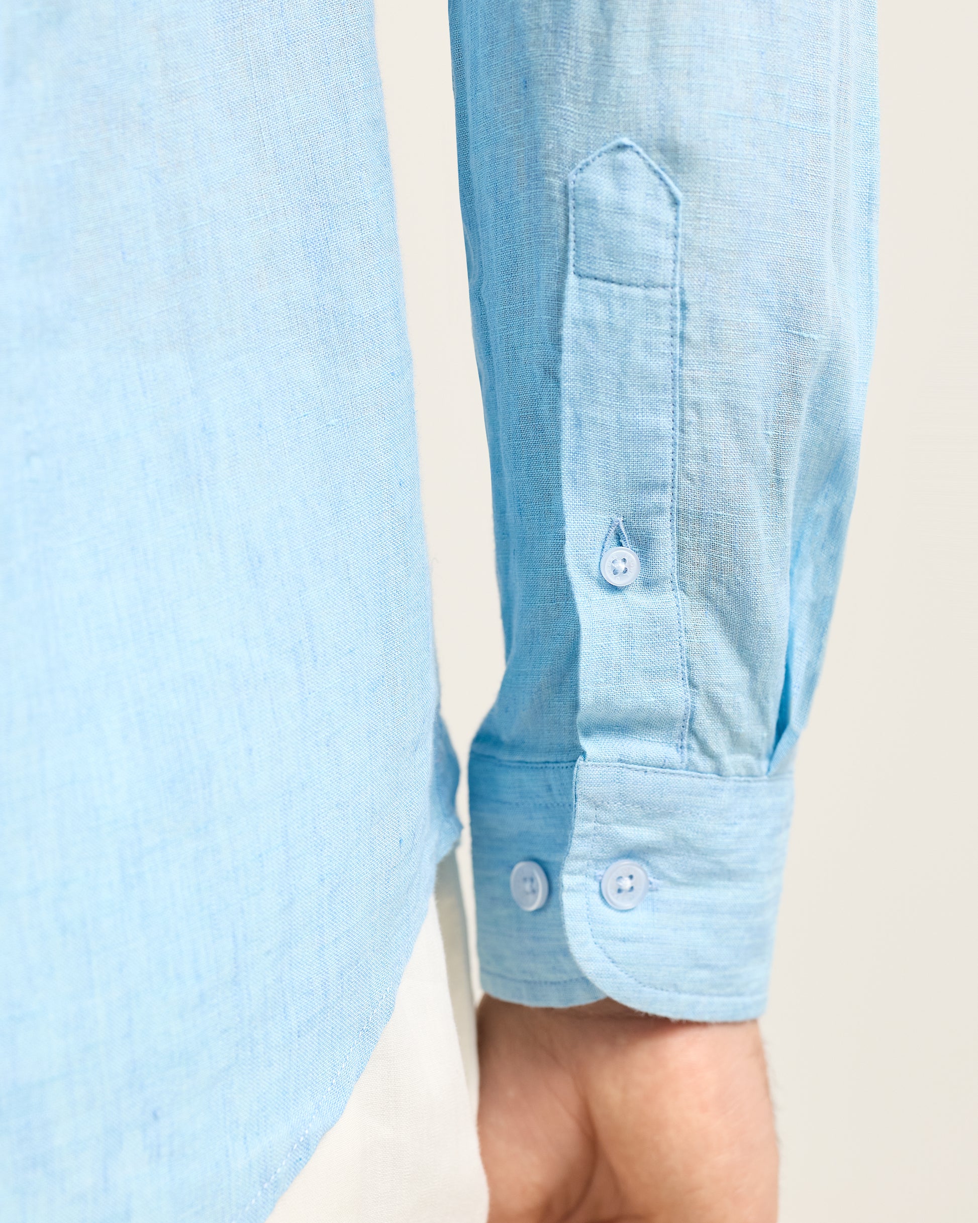 Light blue shirt with a pocket detail on a light background
