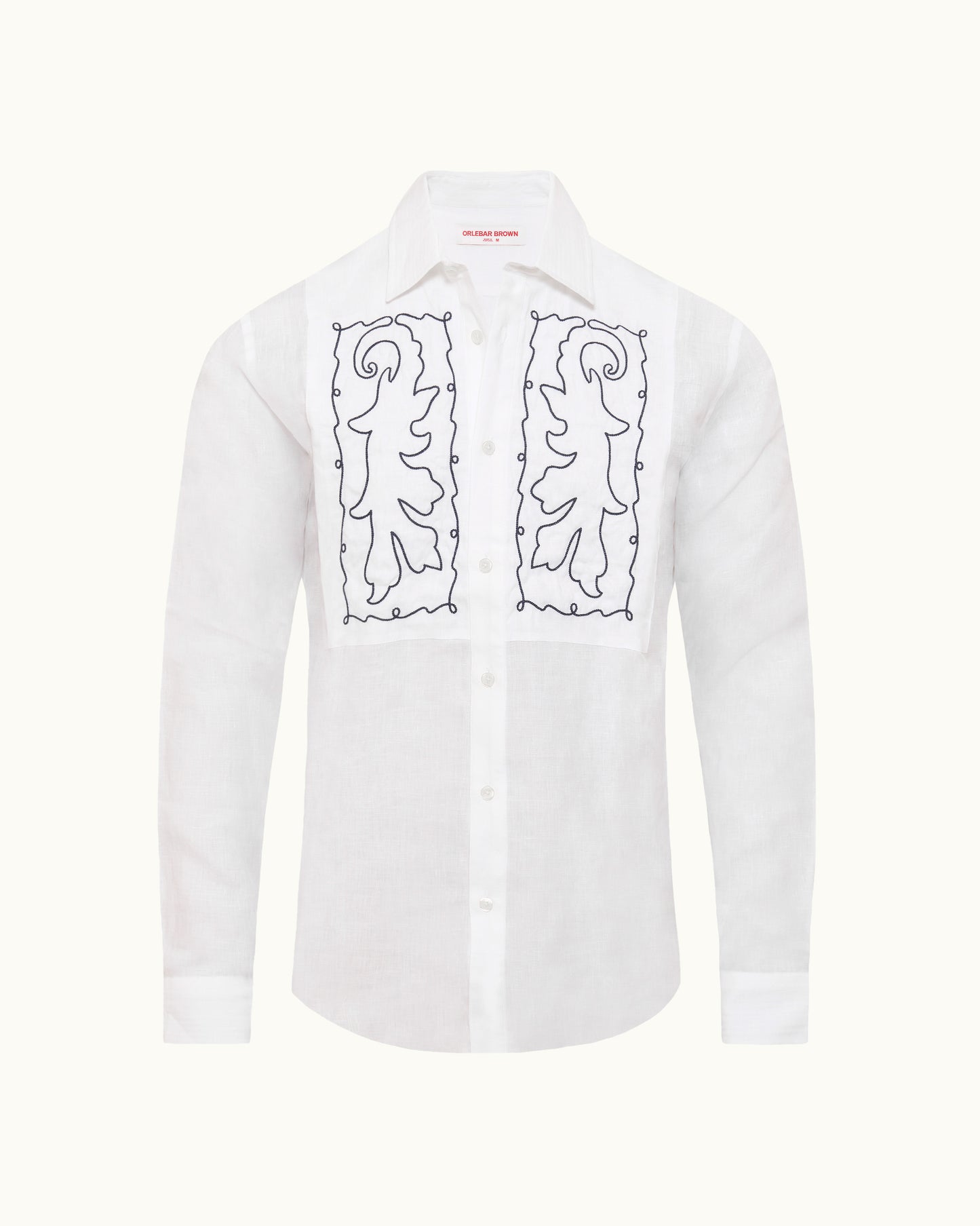 White shirt with navy bib embroidery on a plain background