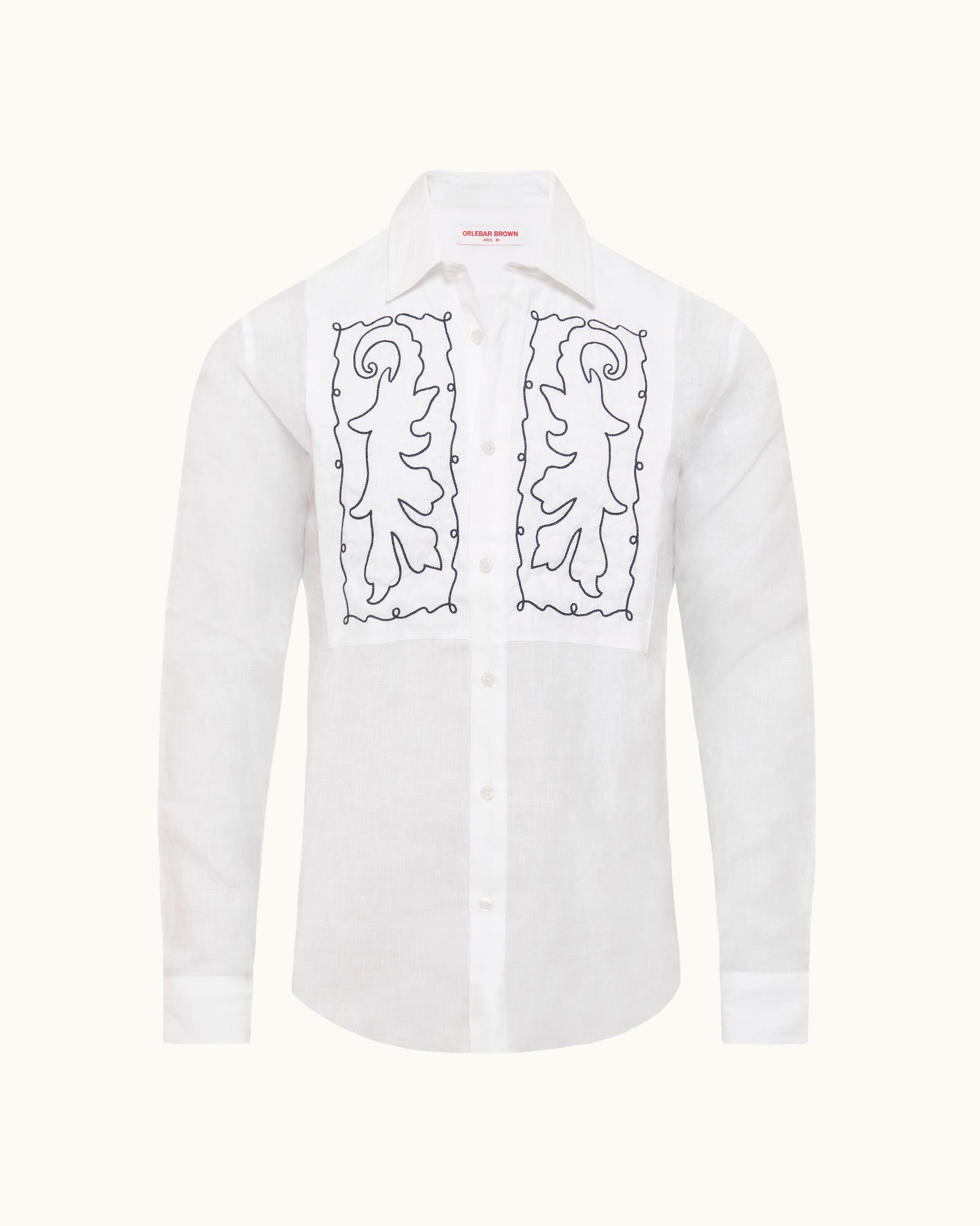 White shirt with navy bib embroidery on a plain background