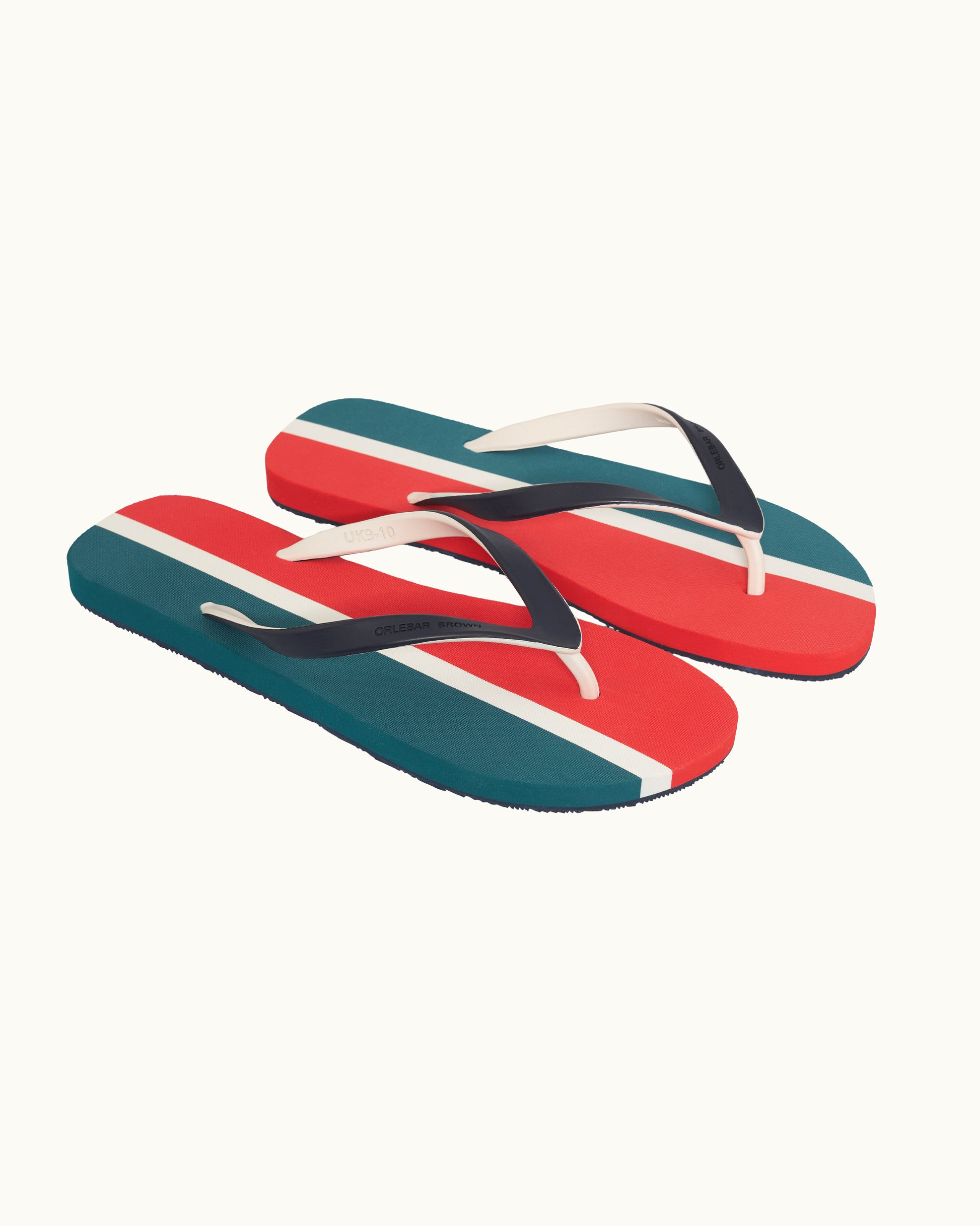 Pair of flip-flops with red, white, and blue stripes on a white background