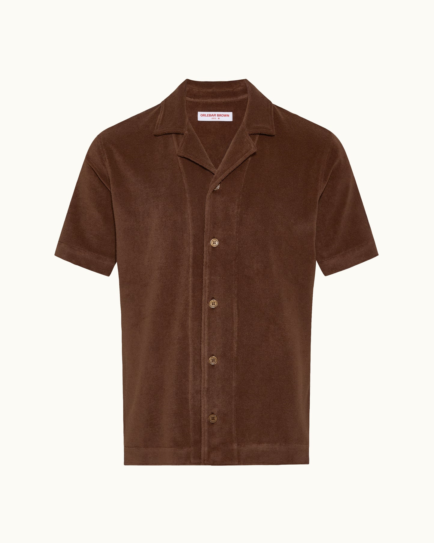 A brown short-sleeve button-up shirt with a corduroy texture, featuring a camp collar and matching buttons, displayed on a clean off-white background.