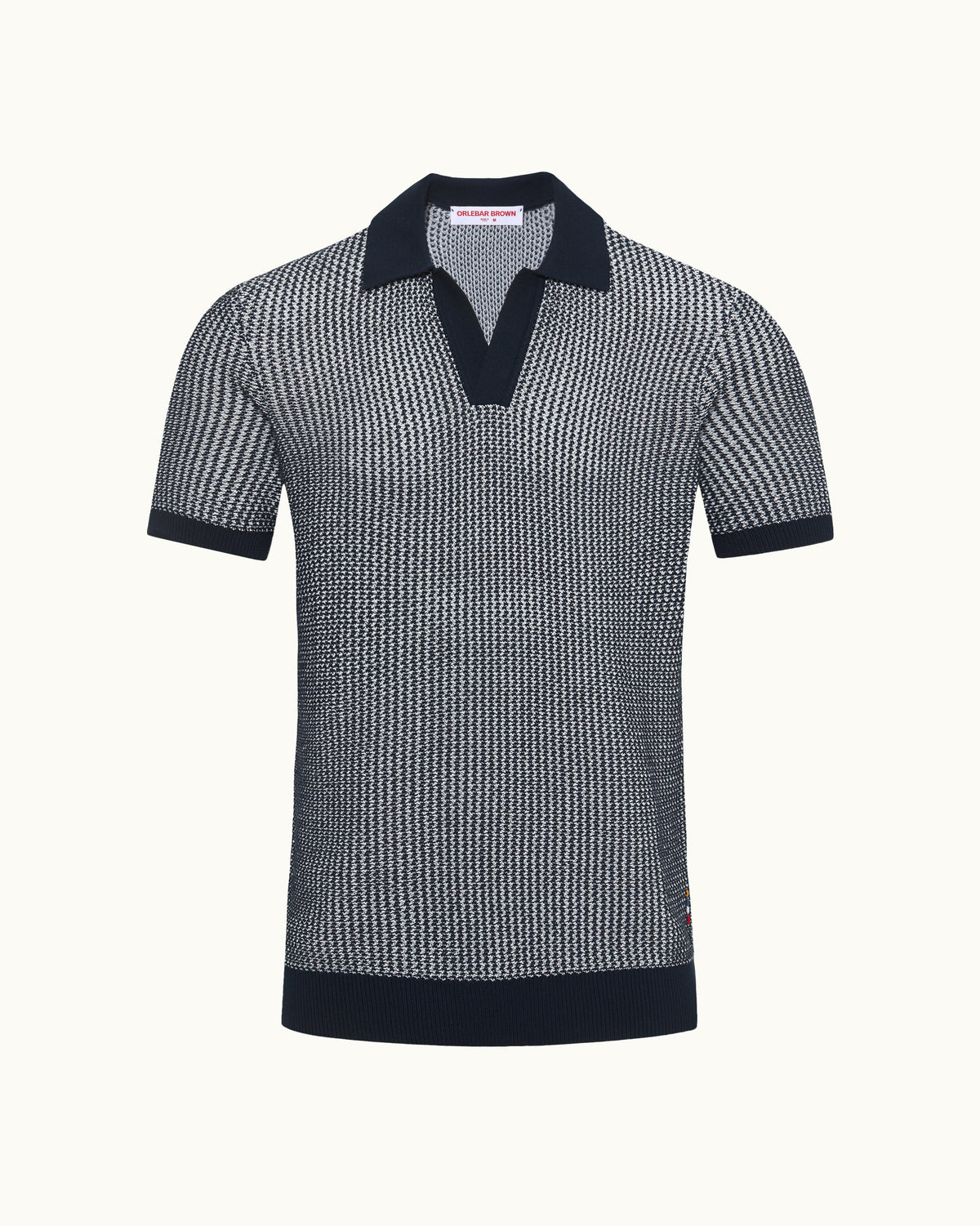 Patterned polo shirt with dark collar and trim on a white background