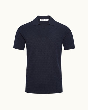 Navy polo shirt on a plain background