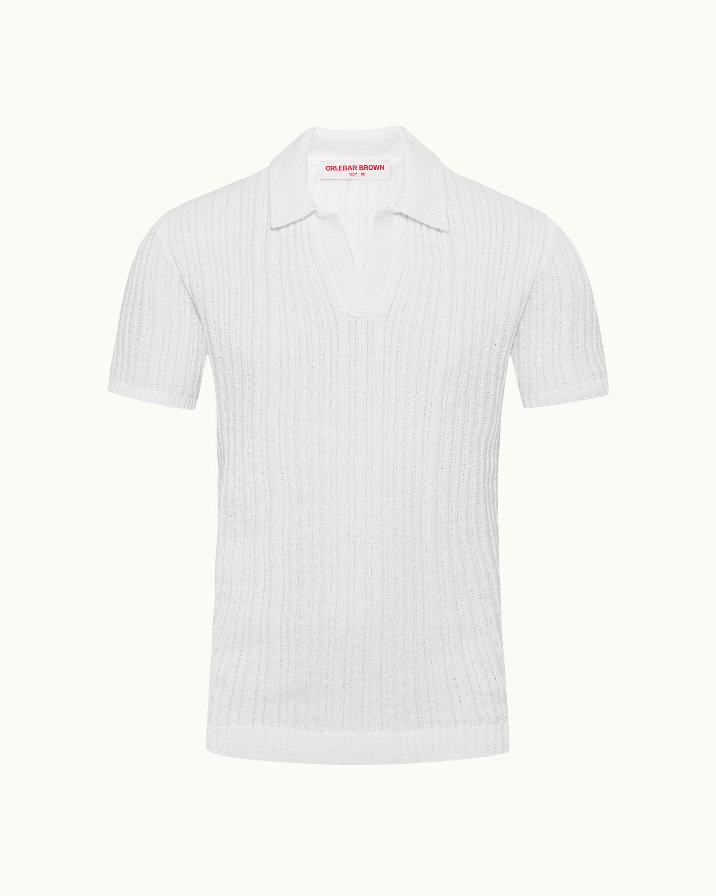 White polo shirt with a small red logo on a white background