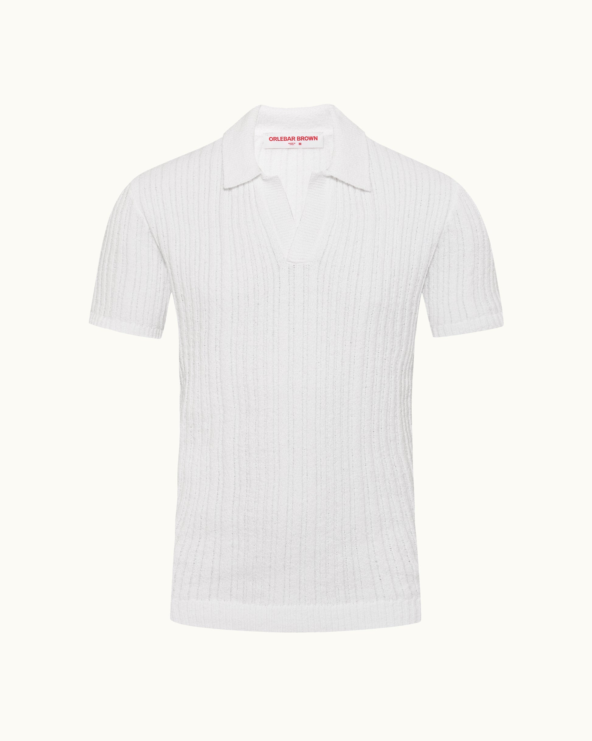 White polo shirt with a small red logo on a white background