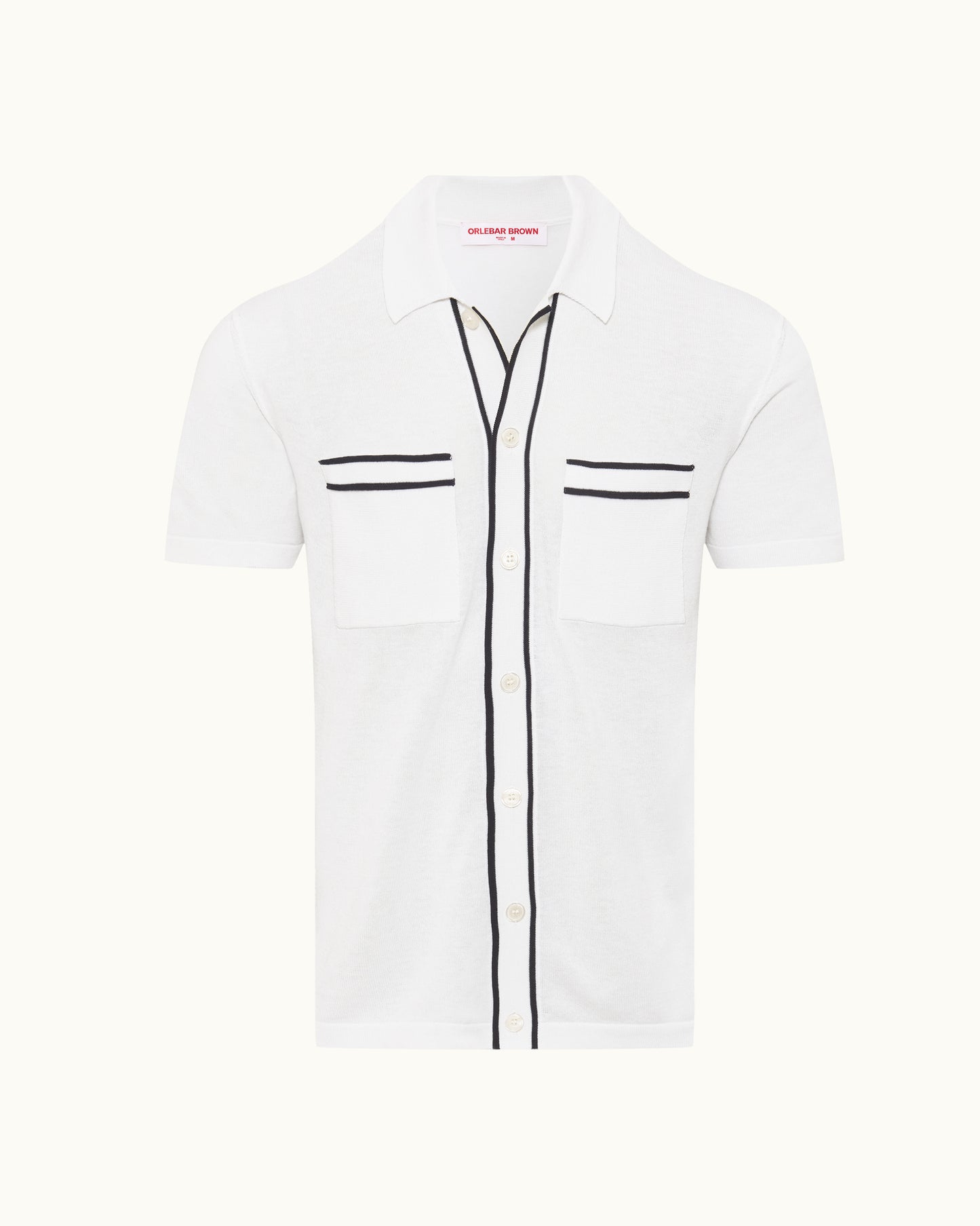 White knit shirt with black trim detailing on a plain background