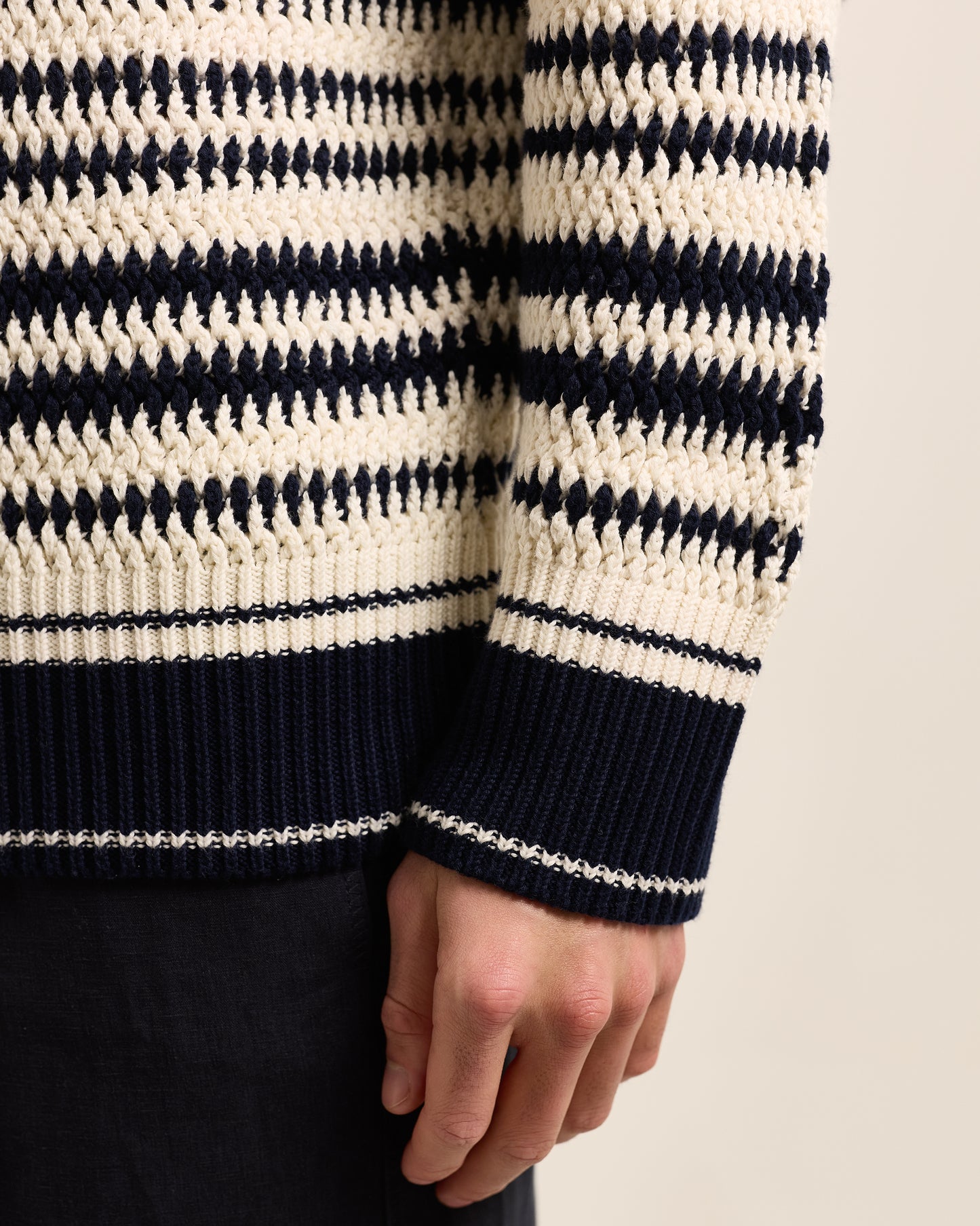 Closeup of knitted navy and white hoodie