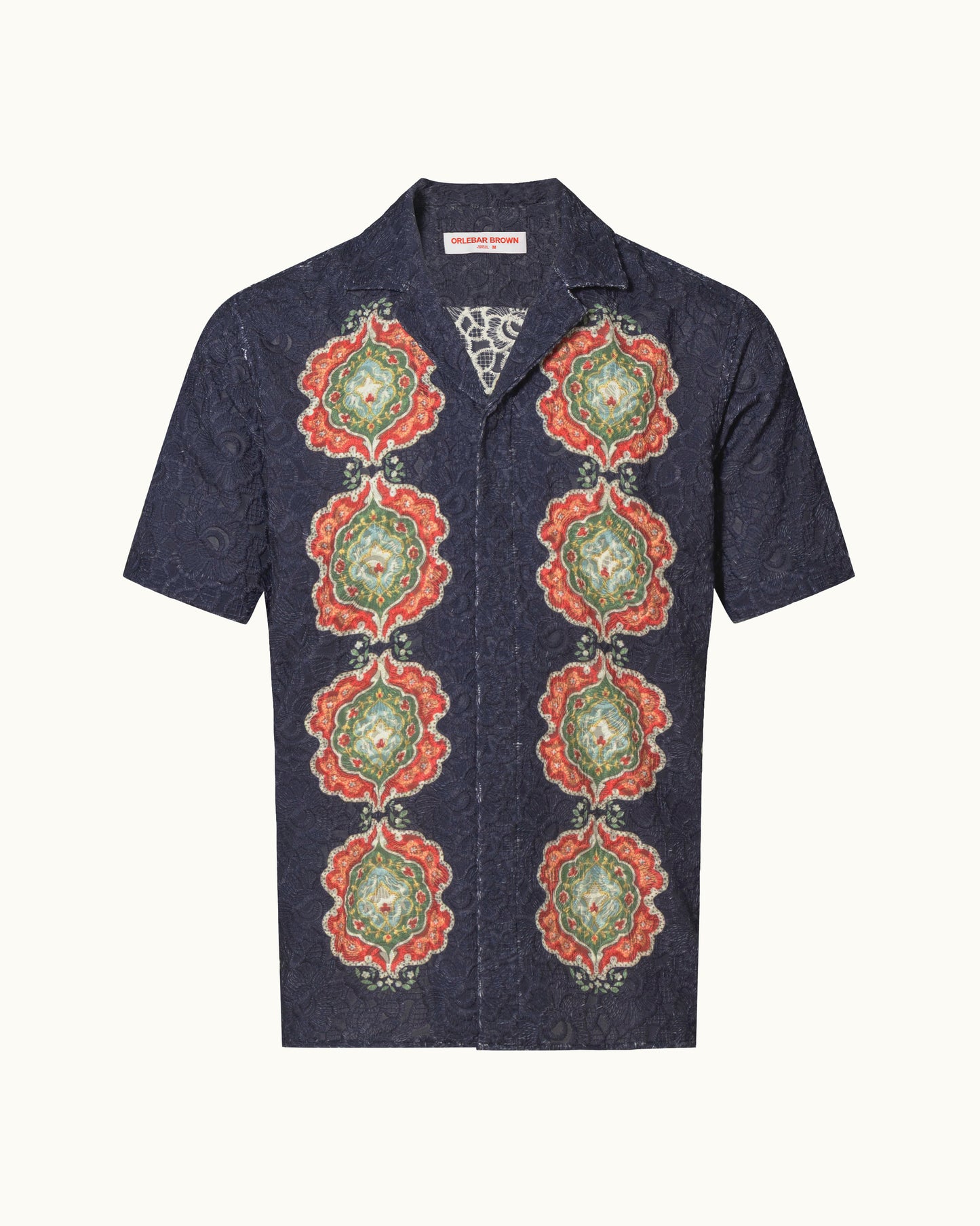 Navy embroidery shirt with colour print detailing on a plain background