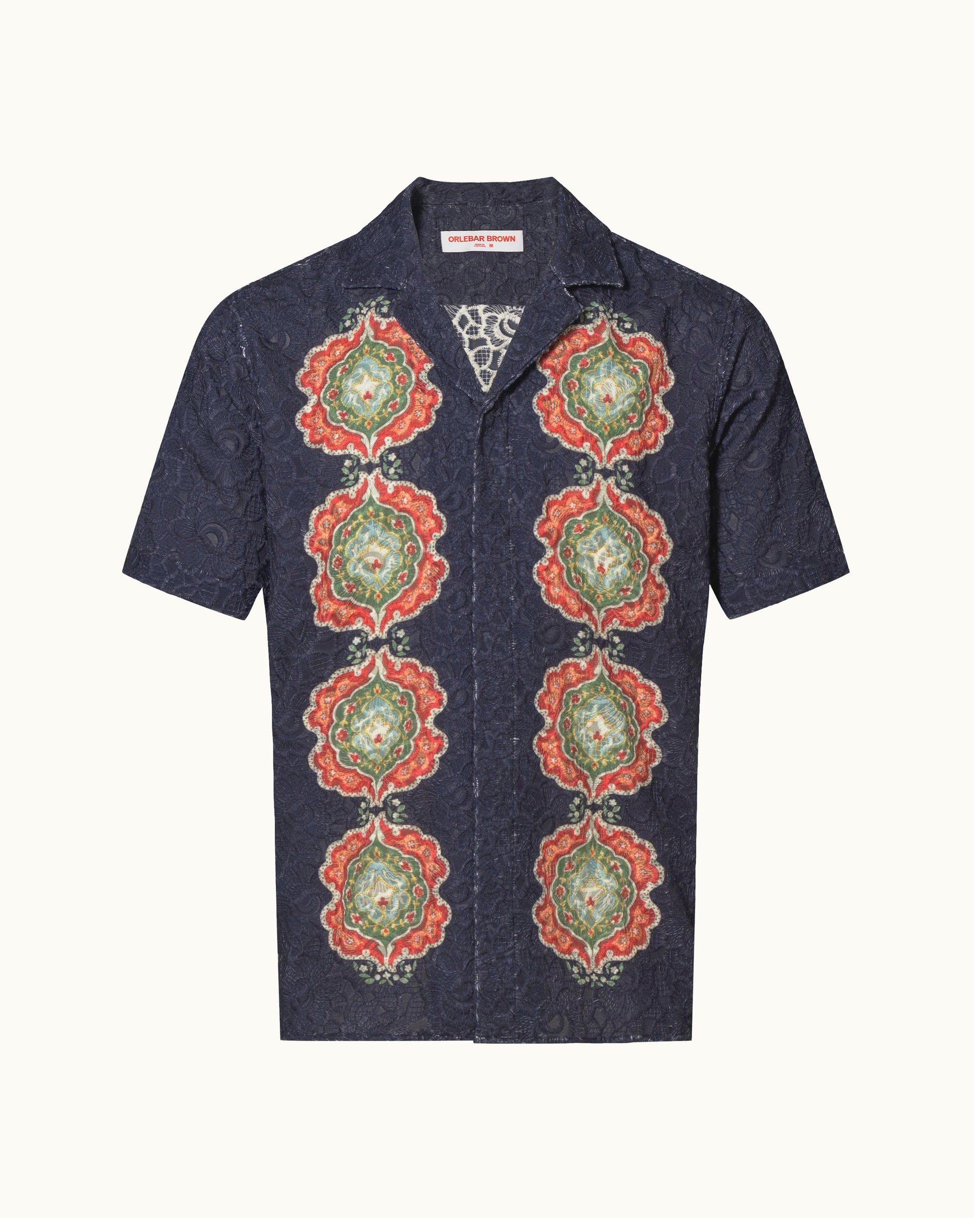 Navy embroidery shirt with colour print detailing on a plain background
