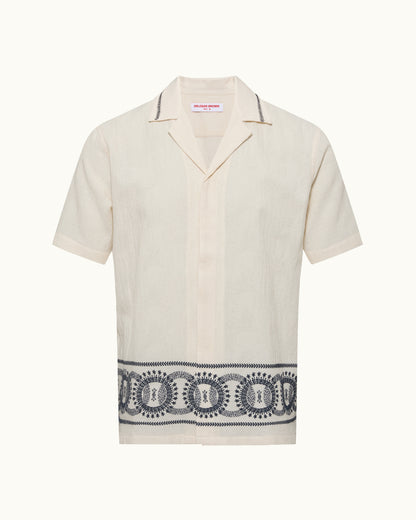 Beige shirt with black patterned band on a white background