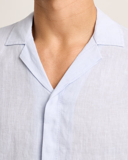 Close-up of light blue shirt on a plain background