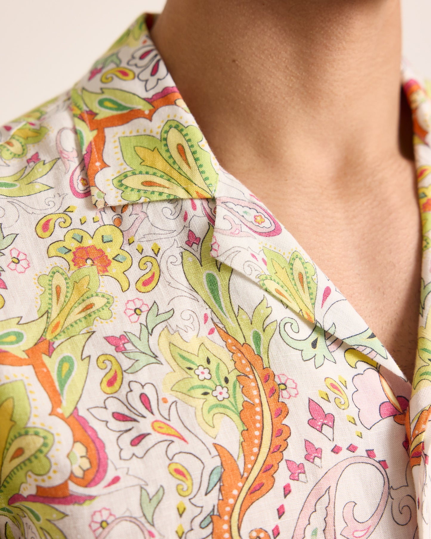 Close-up of a colorful patterned shirt with a neutral background