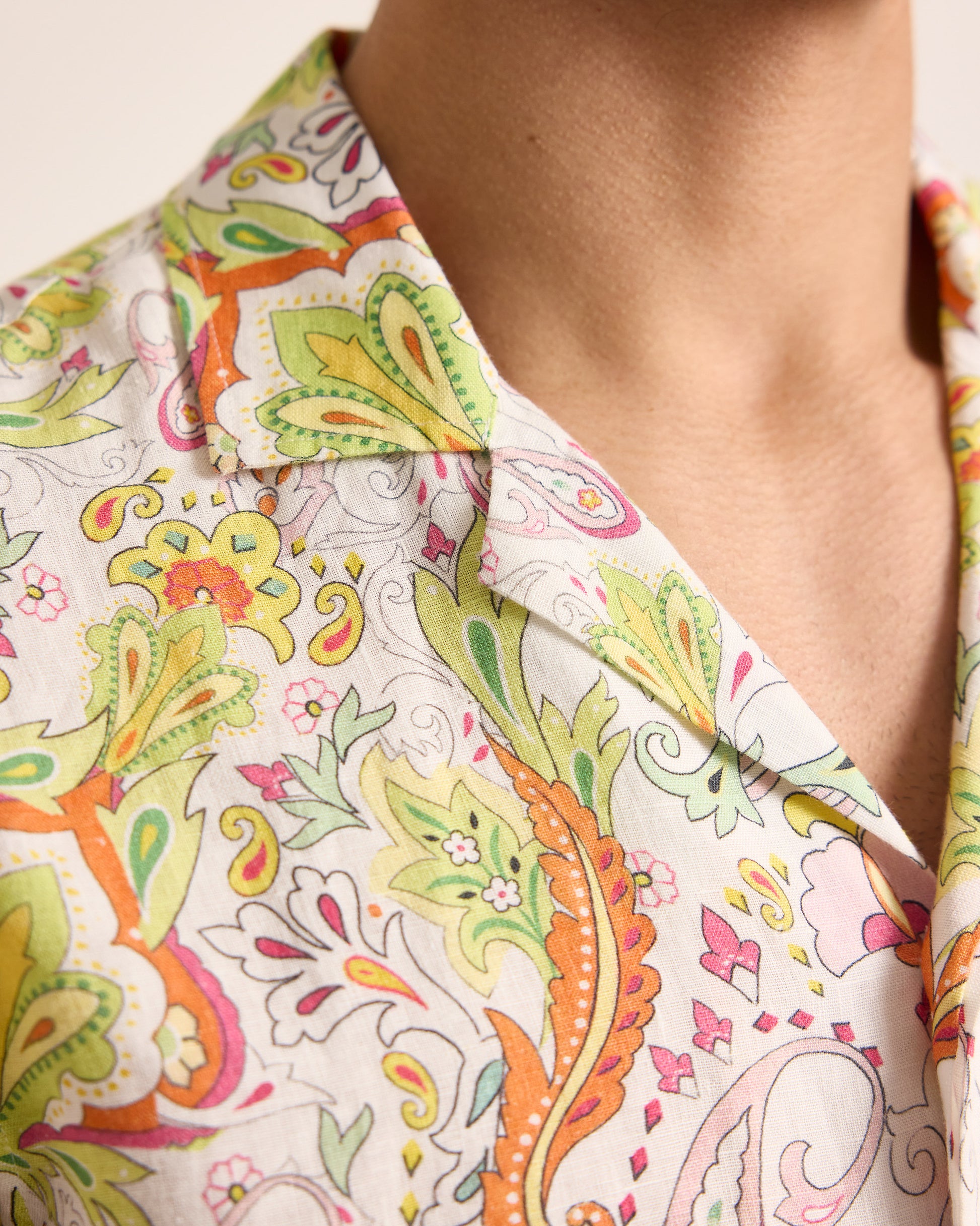 Close-up of a colorful patterned shirt with a neutral background