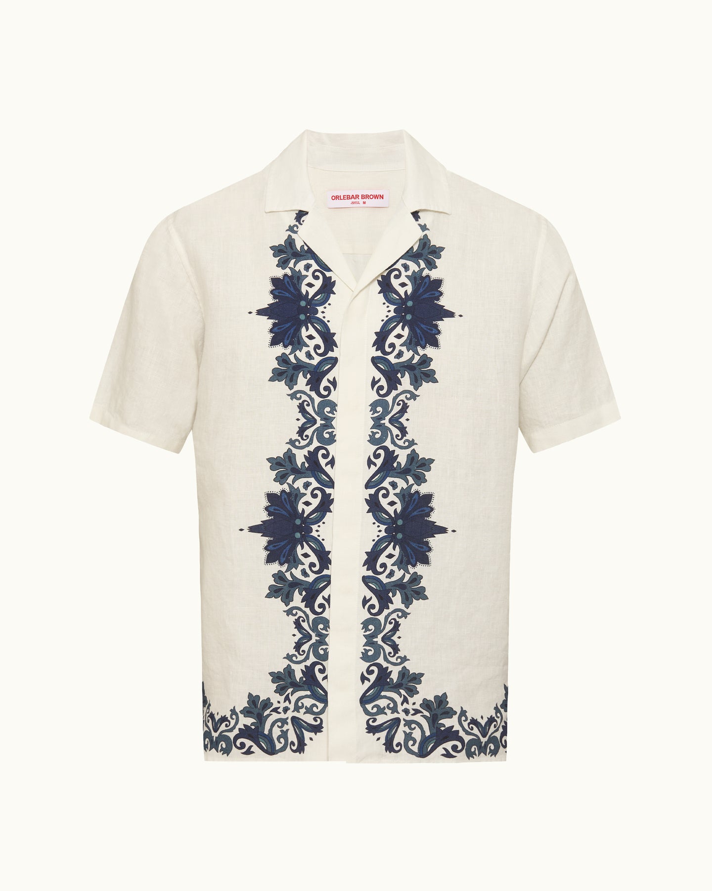 White shirt with blue floral embroidery on a white background