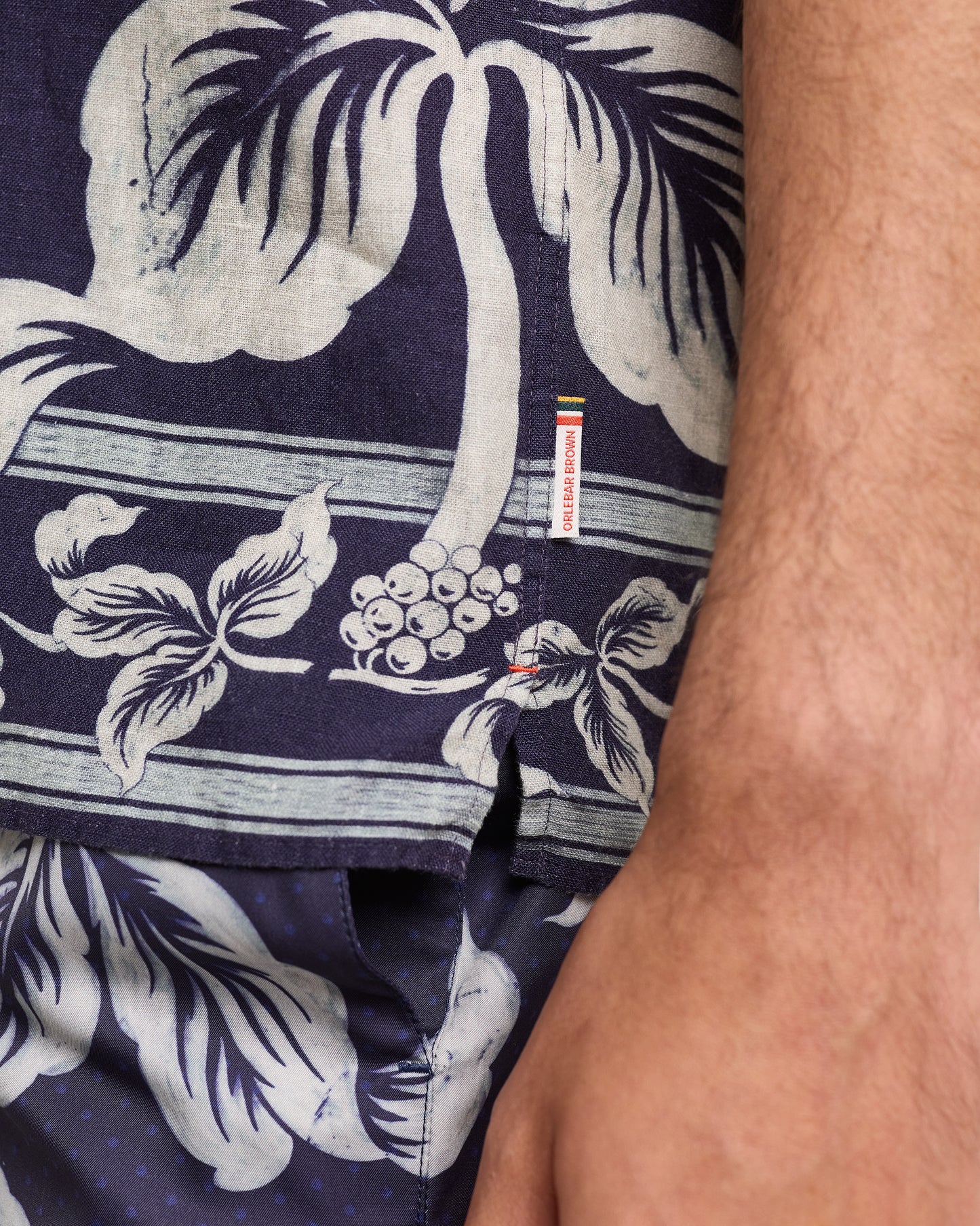 Close-up of navy blue shirt with white floral  pattern on a white background