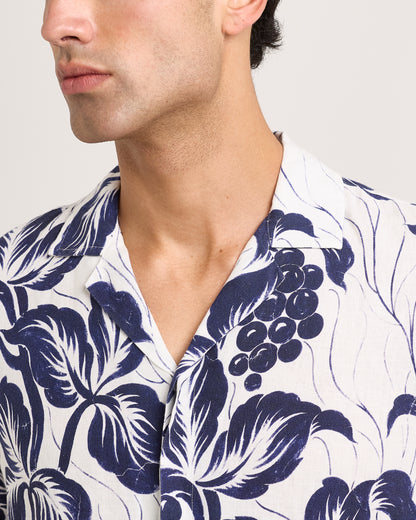 Man wearing a white shirt with blue floral pattern