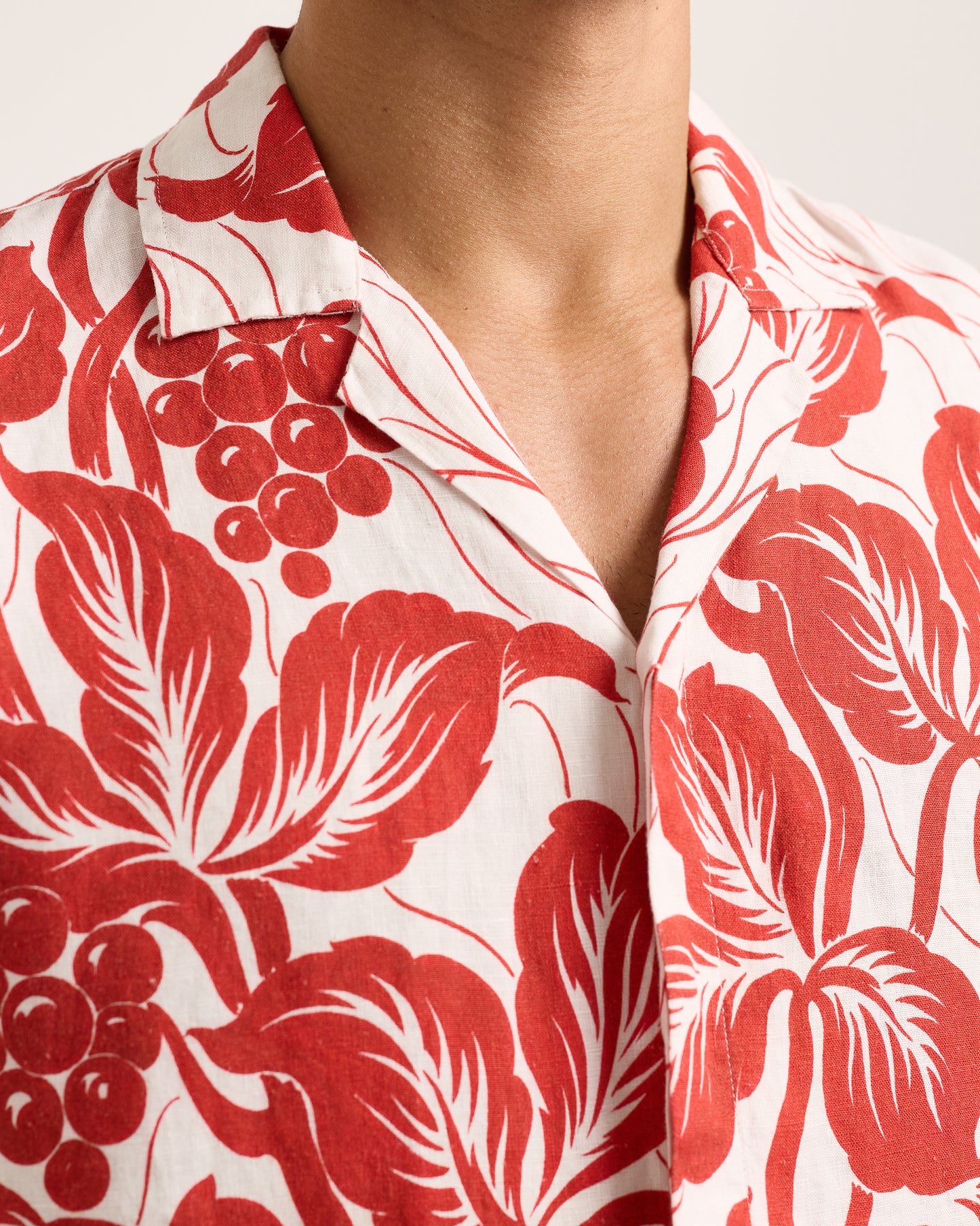 Close-up of red floral patterned shirt on a white background