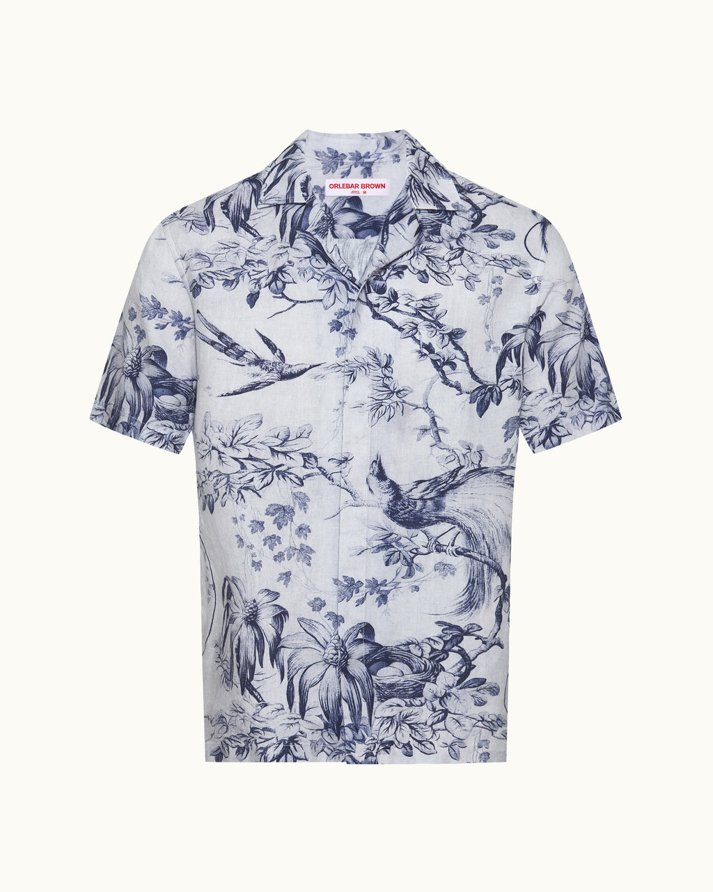 White shirt with blue floral and bird pattern on a white background