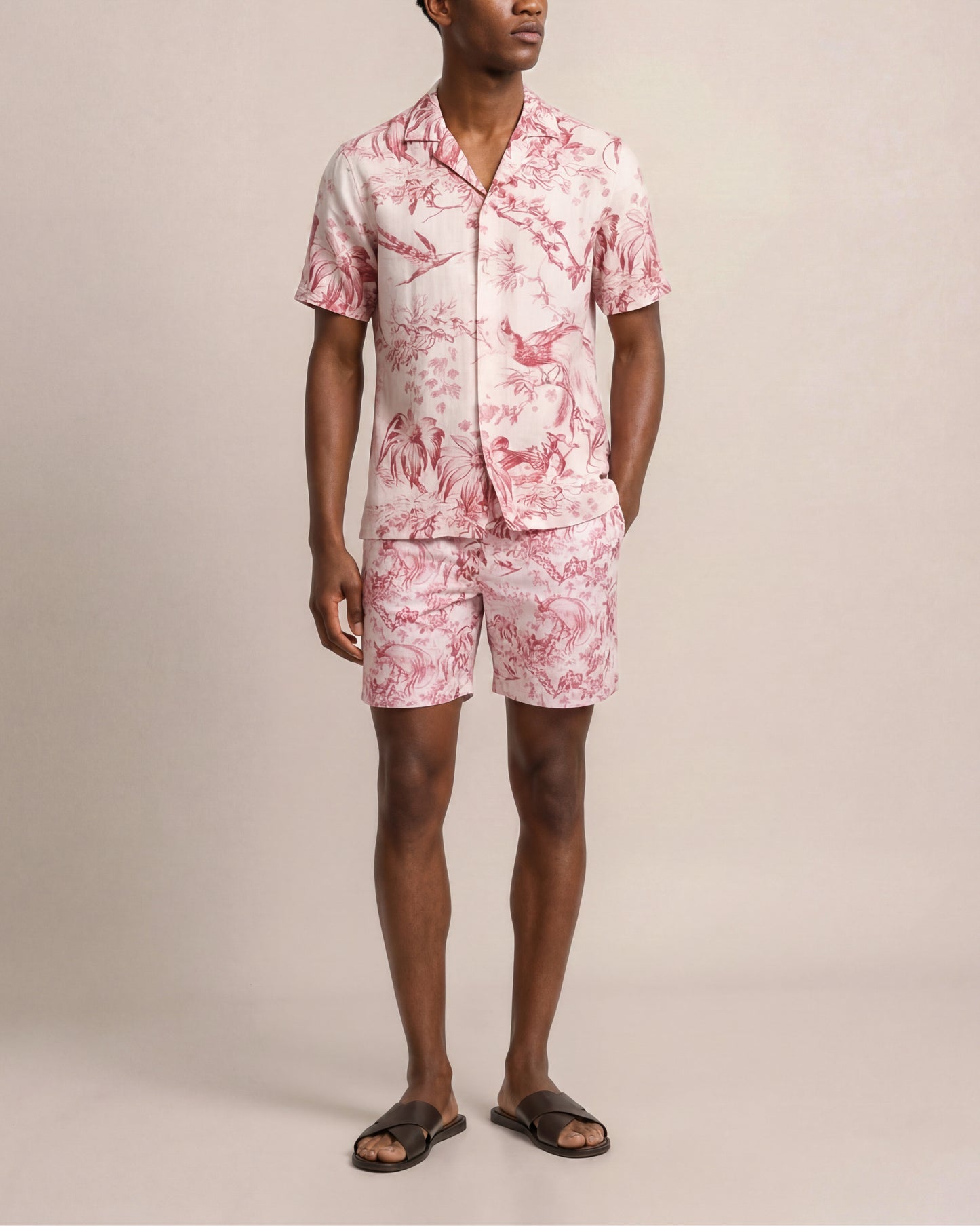 Person wearing a pink floral set on a beige background