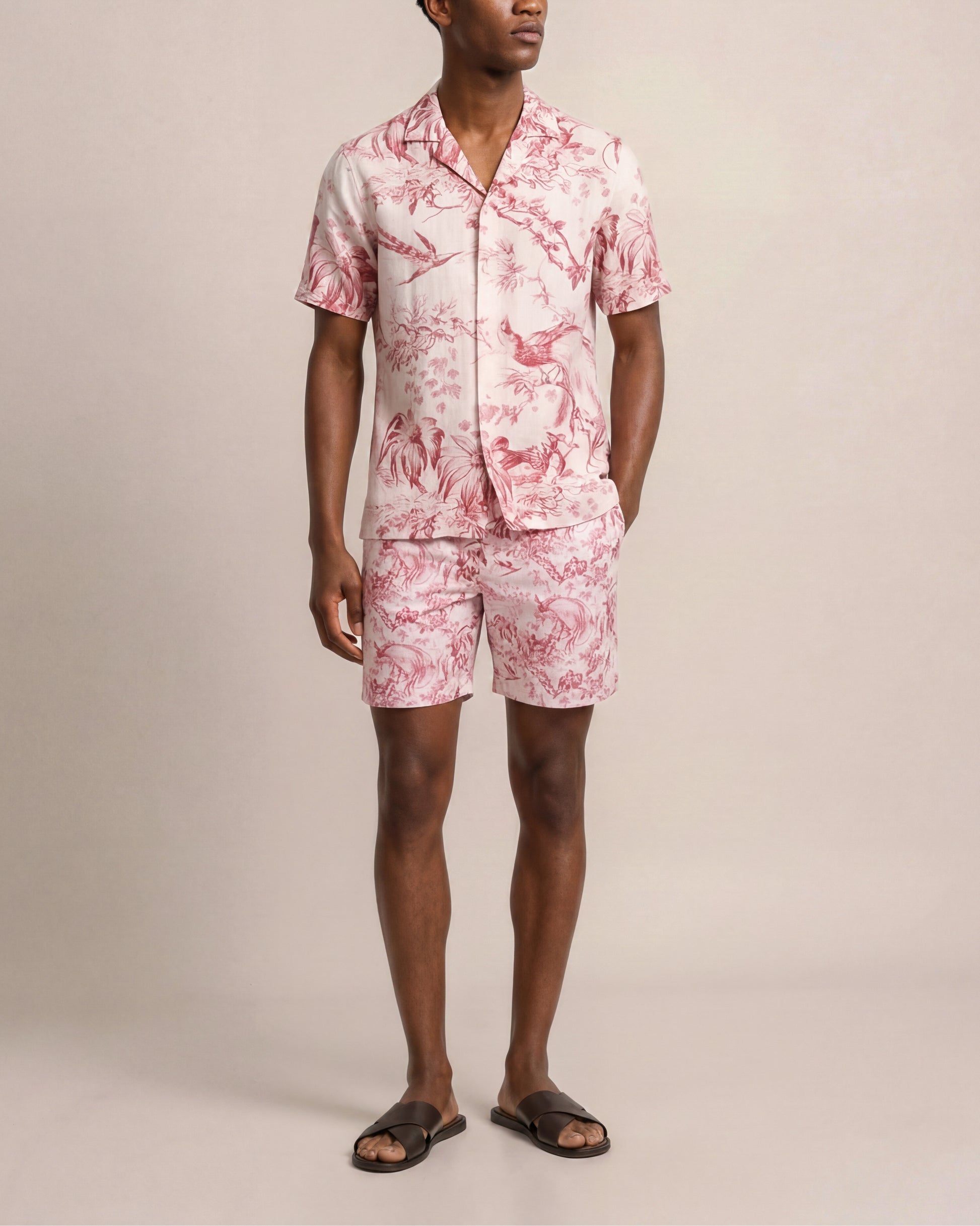 Person wearing a pink floral set on a beige background