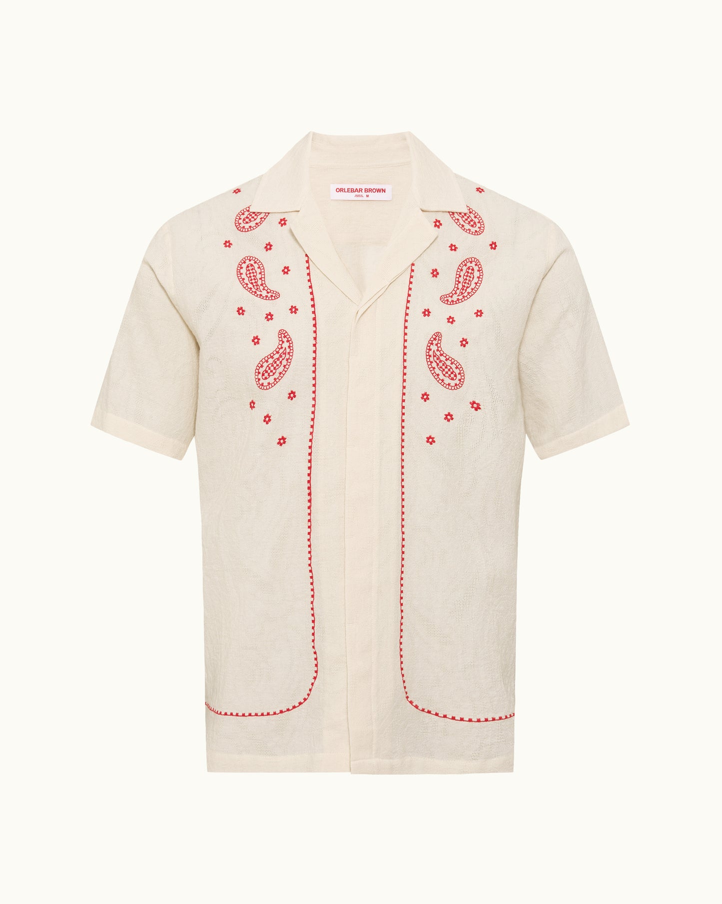 Beige shirt with red paisley patterns on a white background