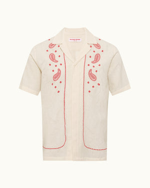 Beige shirt with red paisley patterns on a white background