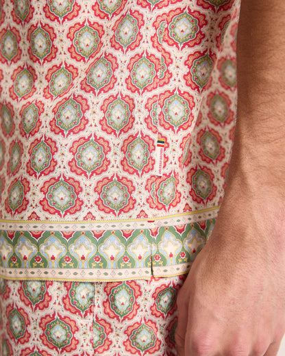 Close-up of a patterned fabric with intricate designs on a white background
