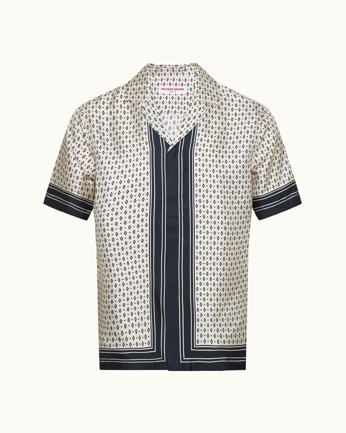 Beige patterned silk shirt with short sleeves and dark navy trim on a white background.