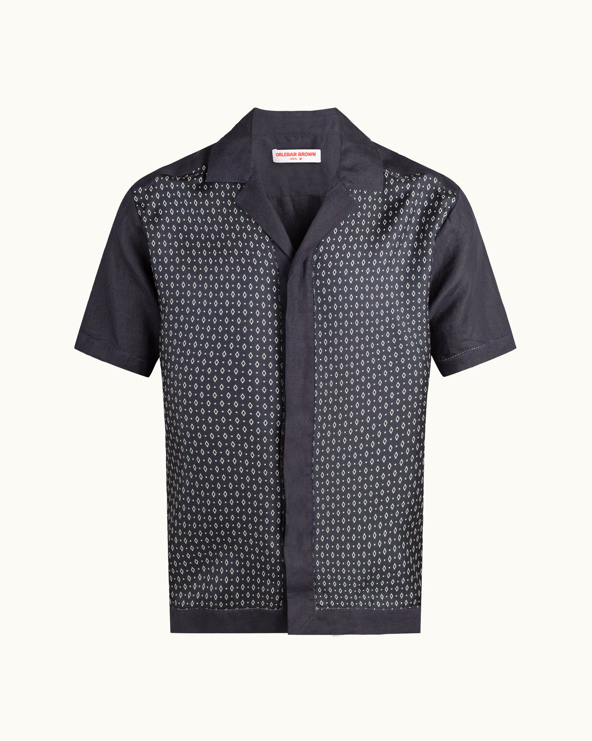 A short-sleeve button-up shirt, featuring a dark navy base with a repeating small white monogram pattern across the body and sleeves, displayed on a white background.
