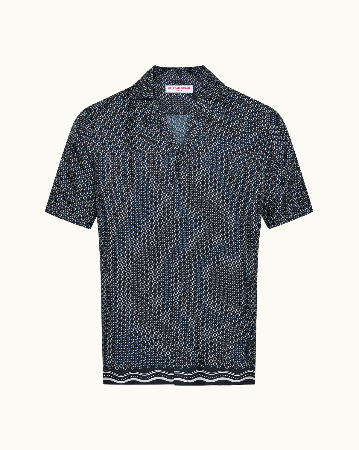 A short-sleeve collared shirt with a dense geometric micro-pattern in navy and white, featuring a striped border at the hem, shown against a plain off-white background.