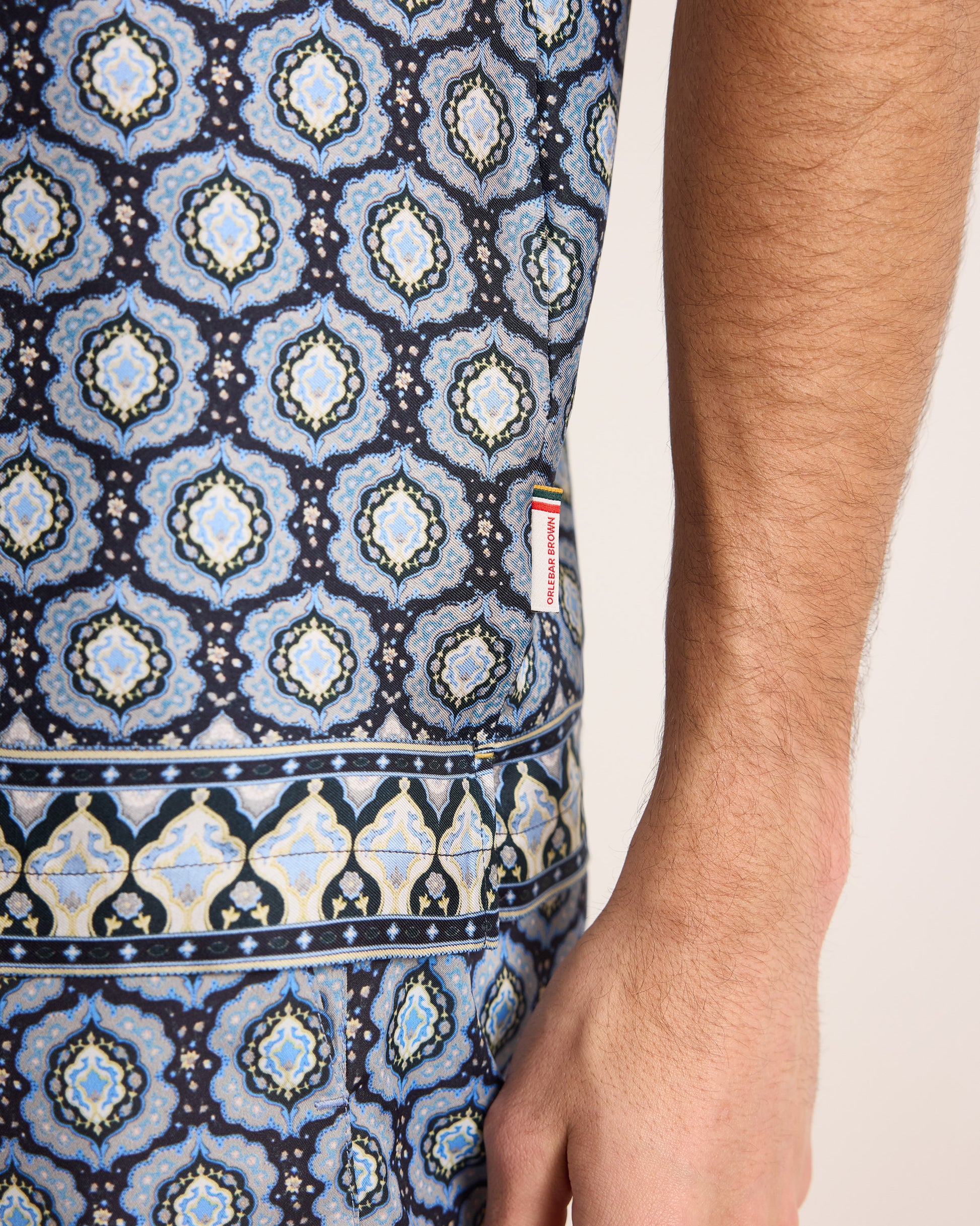 Close-up of a sleeveless top with a geometric pattern on a plain background