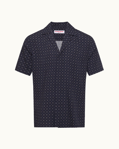 Navy blue polo shirt with white pattern on a white background