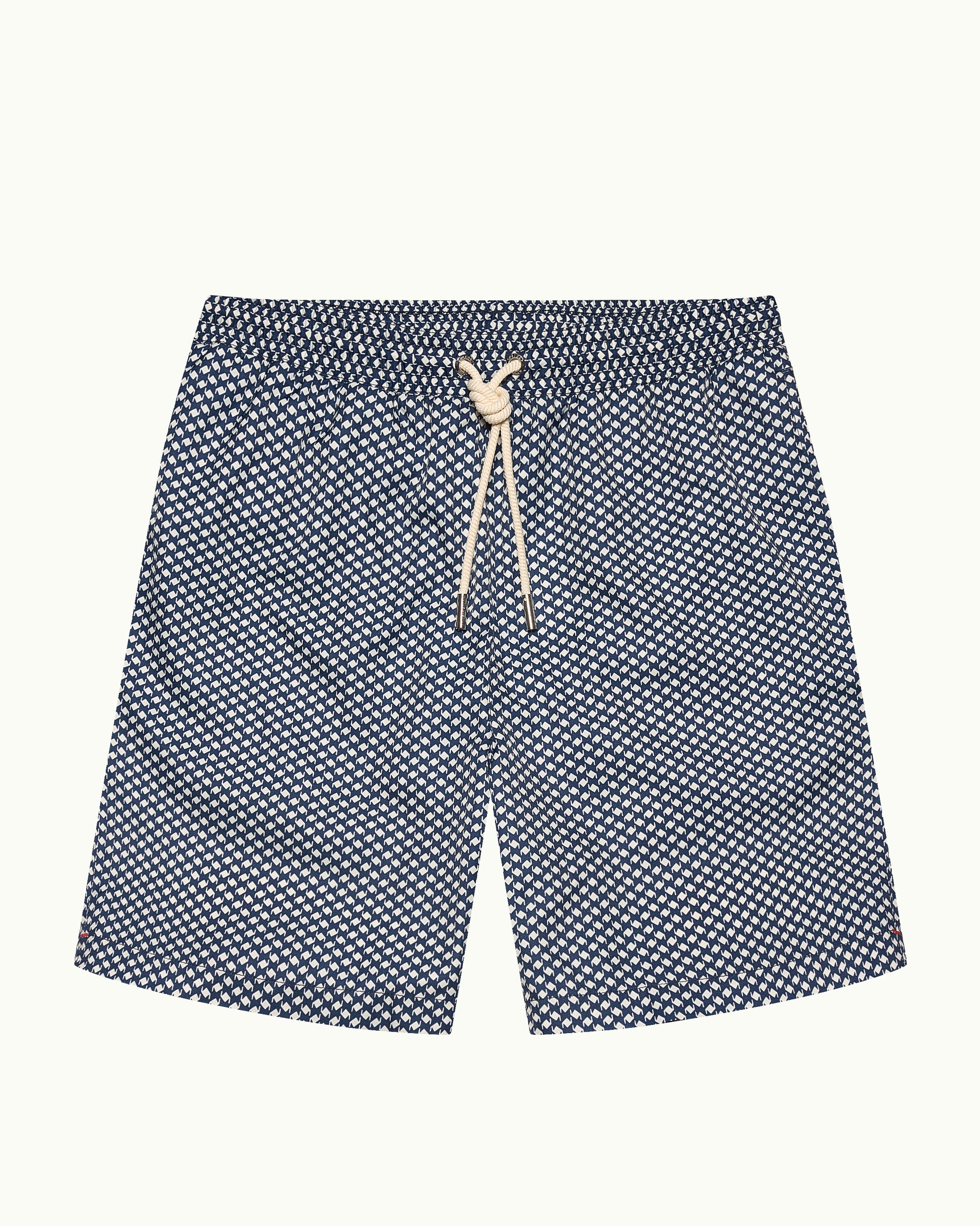 Navy blue shorts with white geometric pattern on a light gray background