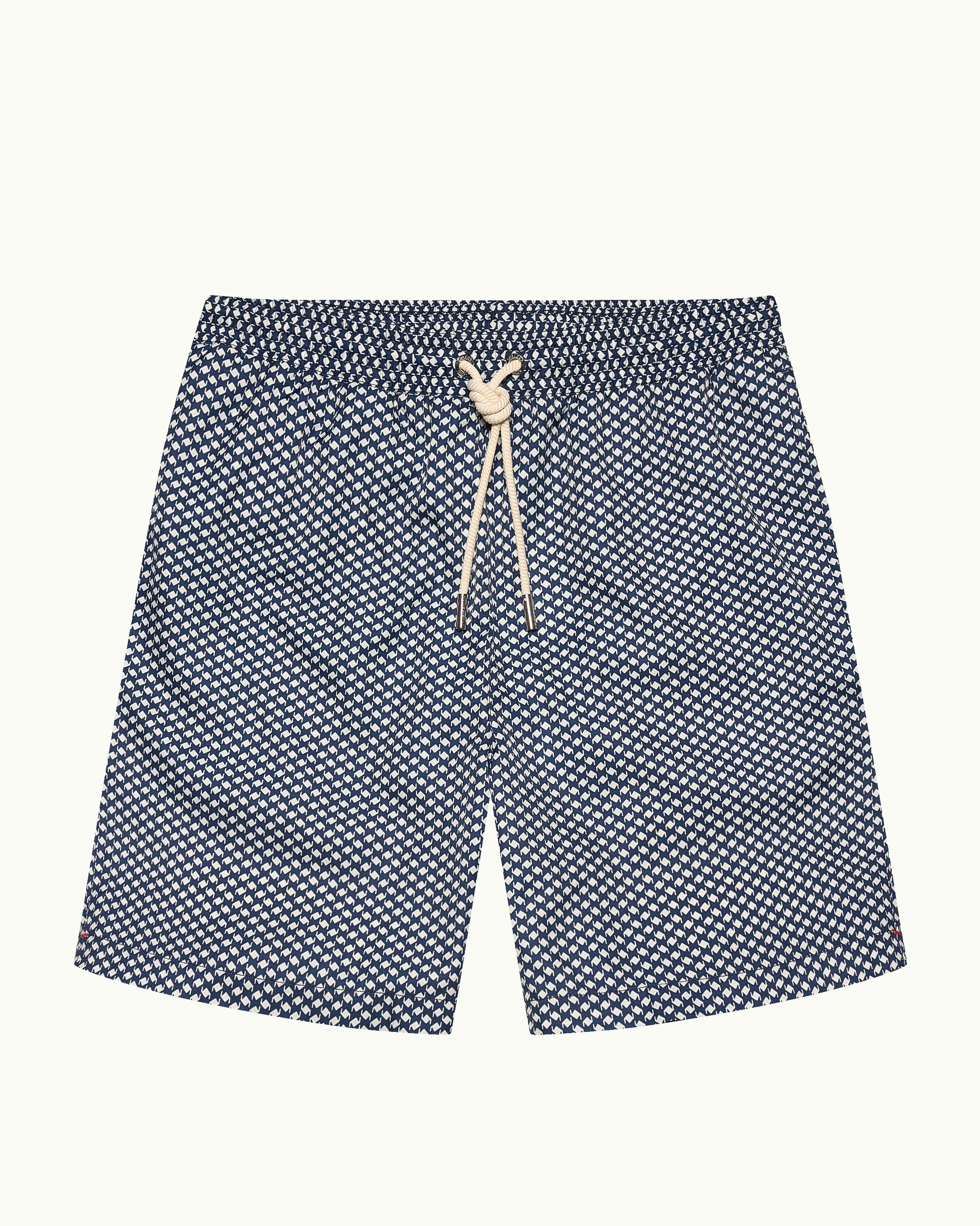 Navy blue shorts with white geometric pattern on a light gray background
