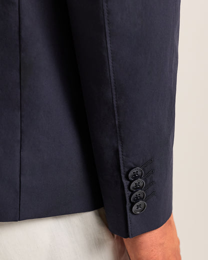 Navy blue suit jacket with button details on a light background
