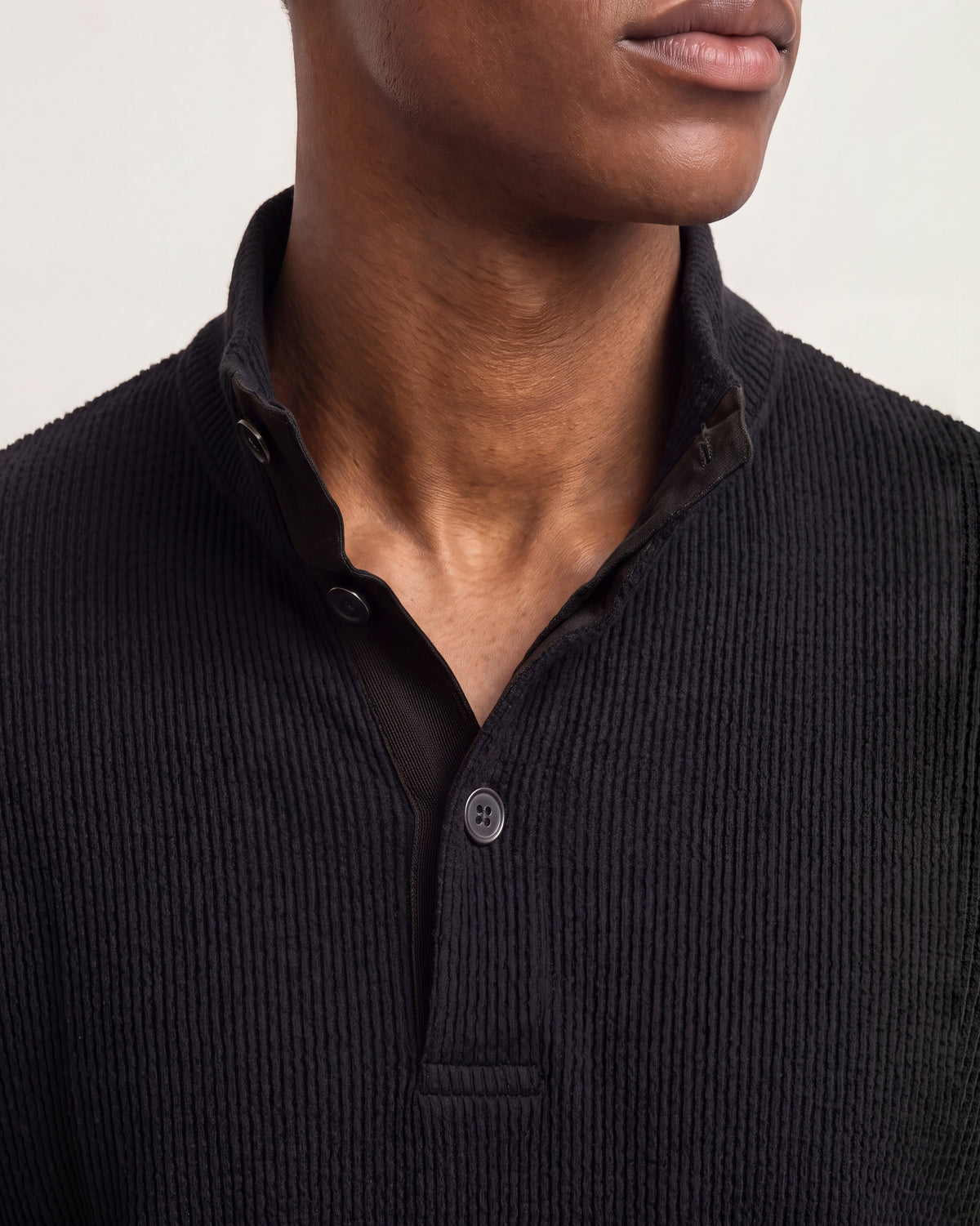 Close-up of dark navy collar 3-button seersucker jumper on a white background
