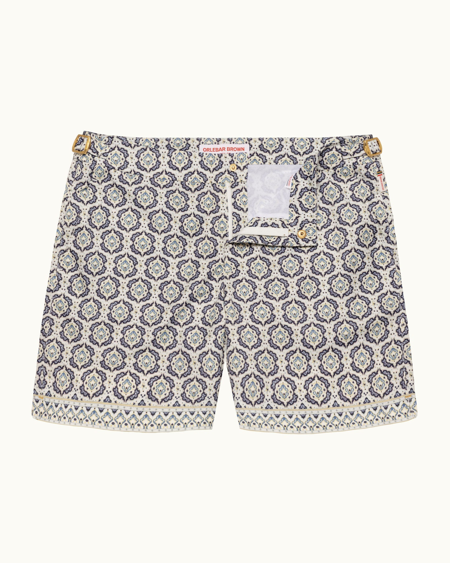 Printed beige swim shorts on a plain background