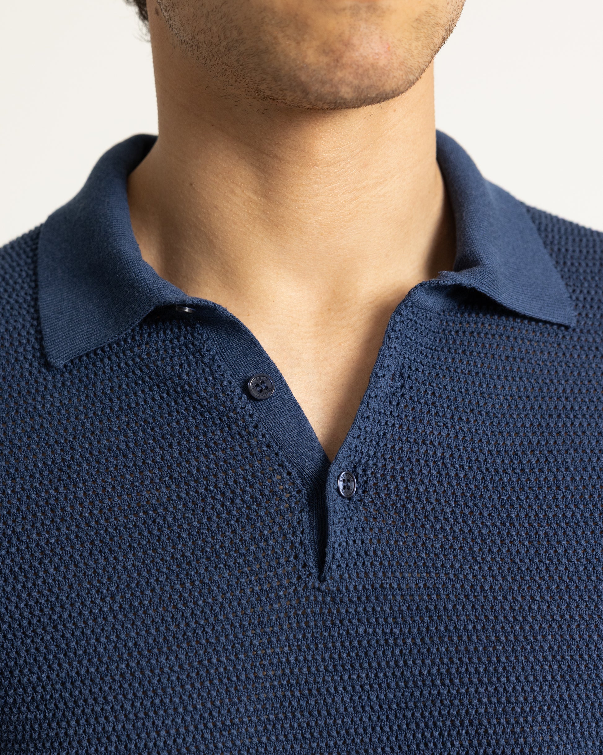 Navy blue textured polo shirt worn by a person