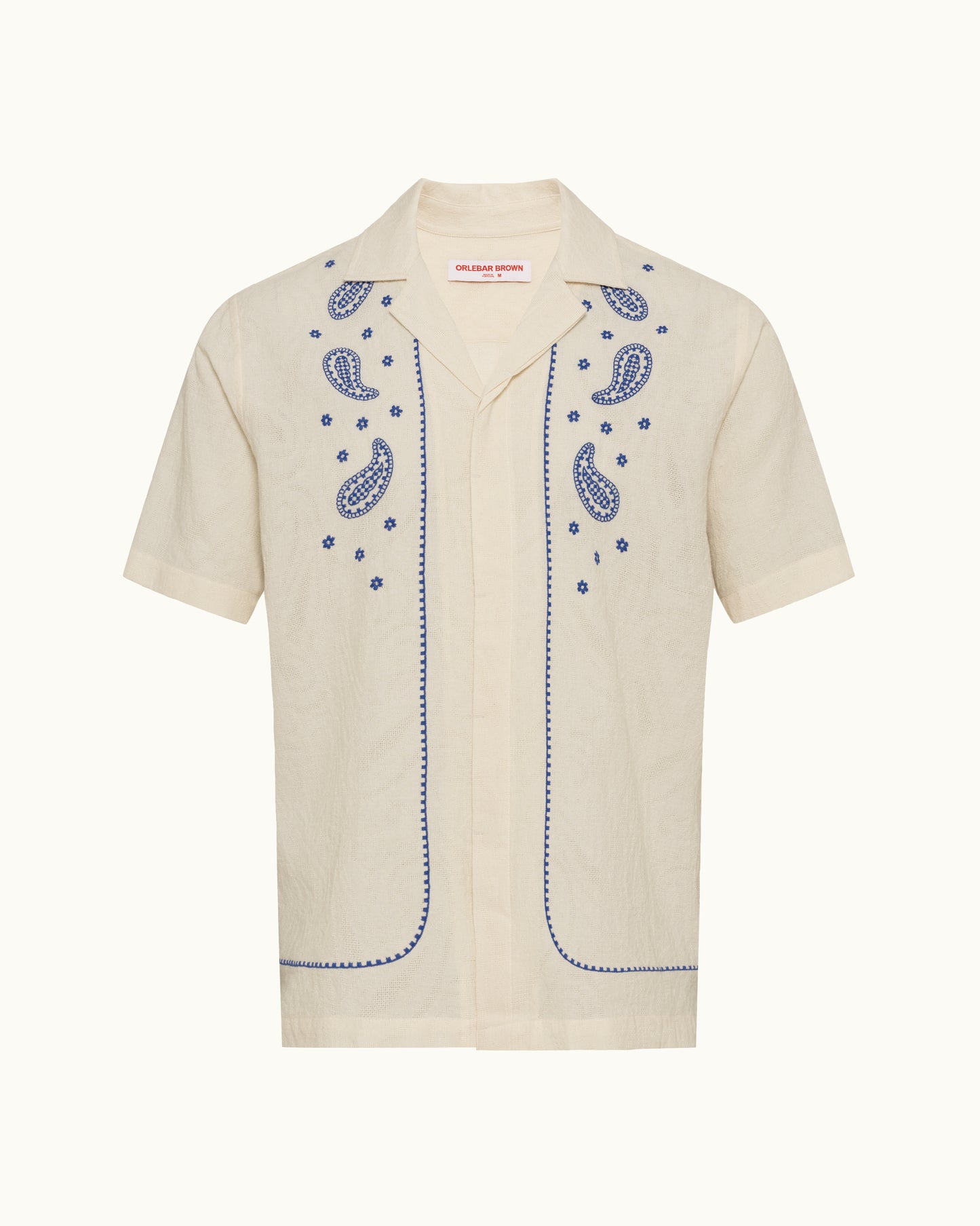 Beige shirt with blue embroidery on a white background